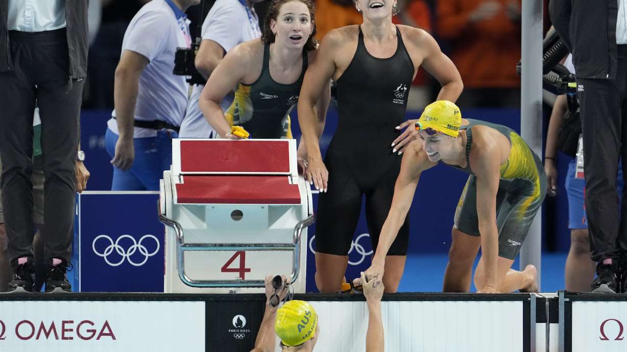Swimmers from Australia celebrate after winning the women's 4x100-meter freestyle relay final at the 2024 Summer Olympics, Saturday, July 27, 2024, in Nanterre, France.