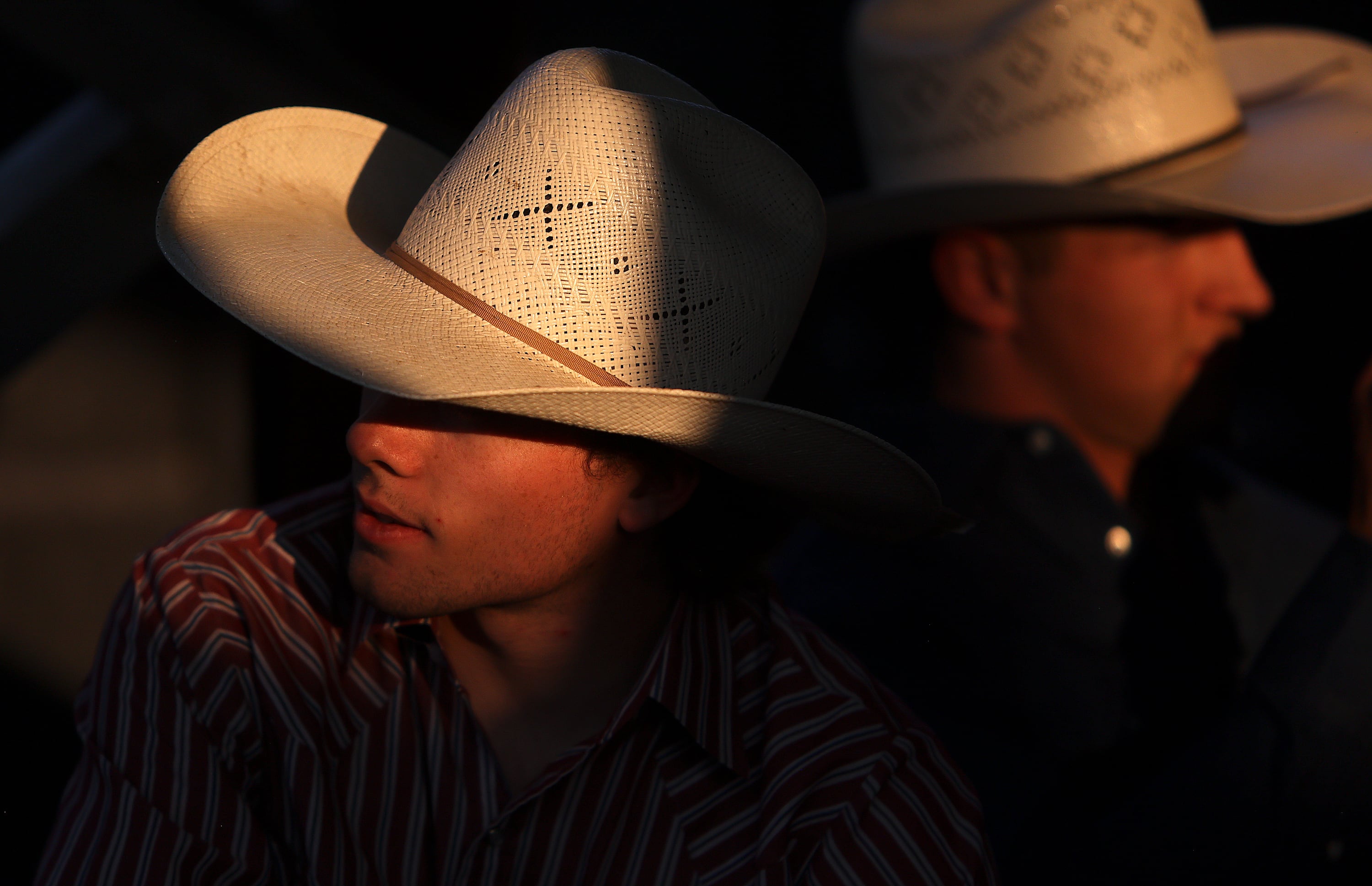 Rawley Johnson of Swan Valley, Idaho, and Dalton Walling, of Carthage, Texas, wait to compete in bull riding at the Days of ’47 Rodeo at the Utah State Fairpark in Salt Lake City on Monday.