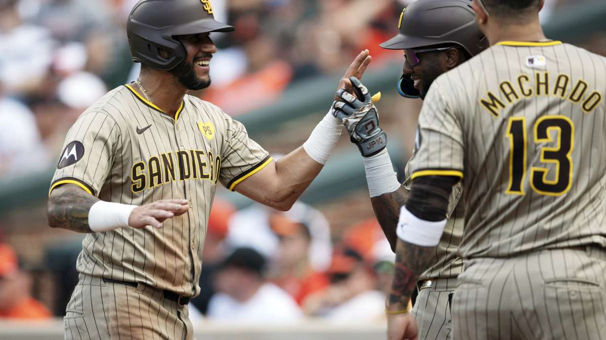 San Diego Padres first base Luis Arraez, left, celebrates with his teammates after scoring in the second inning of a baseball game against Baltimore Orioles, Saturday, July 27, 2024, in Baltimore.