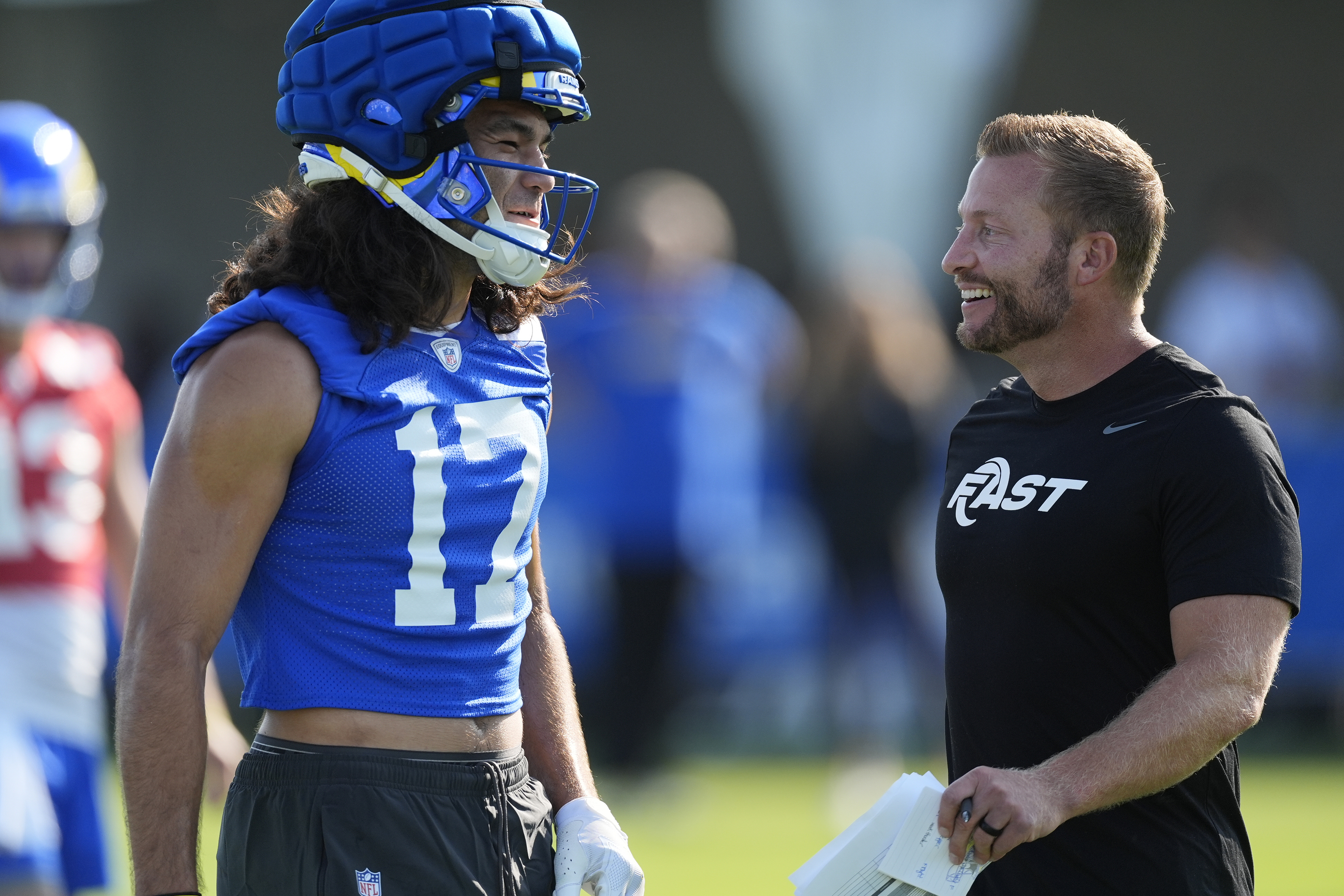 Los Angeles Rams wide receiver Puka Nacua (17) and head coach Sean McVay, right, smile during the NFL football team's training camp Thursday, July 25, 2024, at Loyola Marymount University in Los Angeles. 
