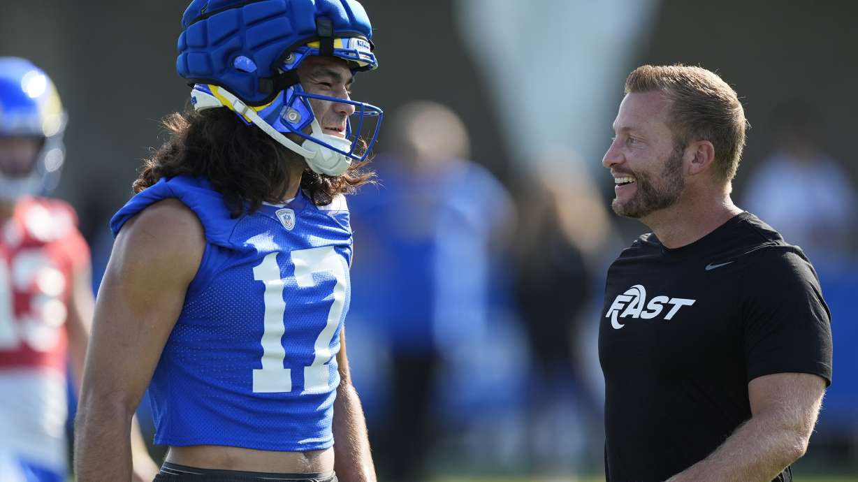Los Angeles Rams wide receiver Puka Nacua (17) and head coach Sean McVay, right, smile during the NFL football team's training camp Thursday, July 25, 2024, at Loyola Marymount University in Los Angeles.