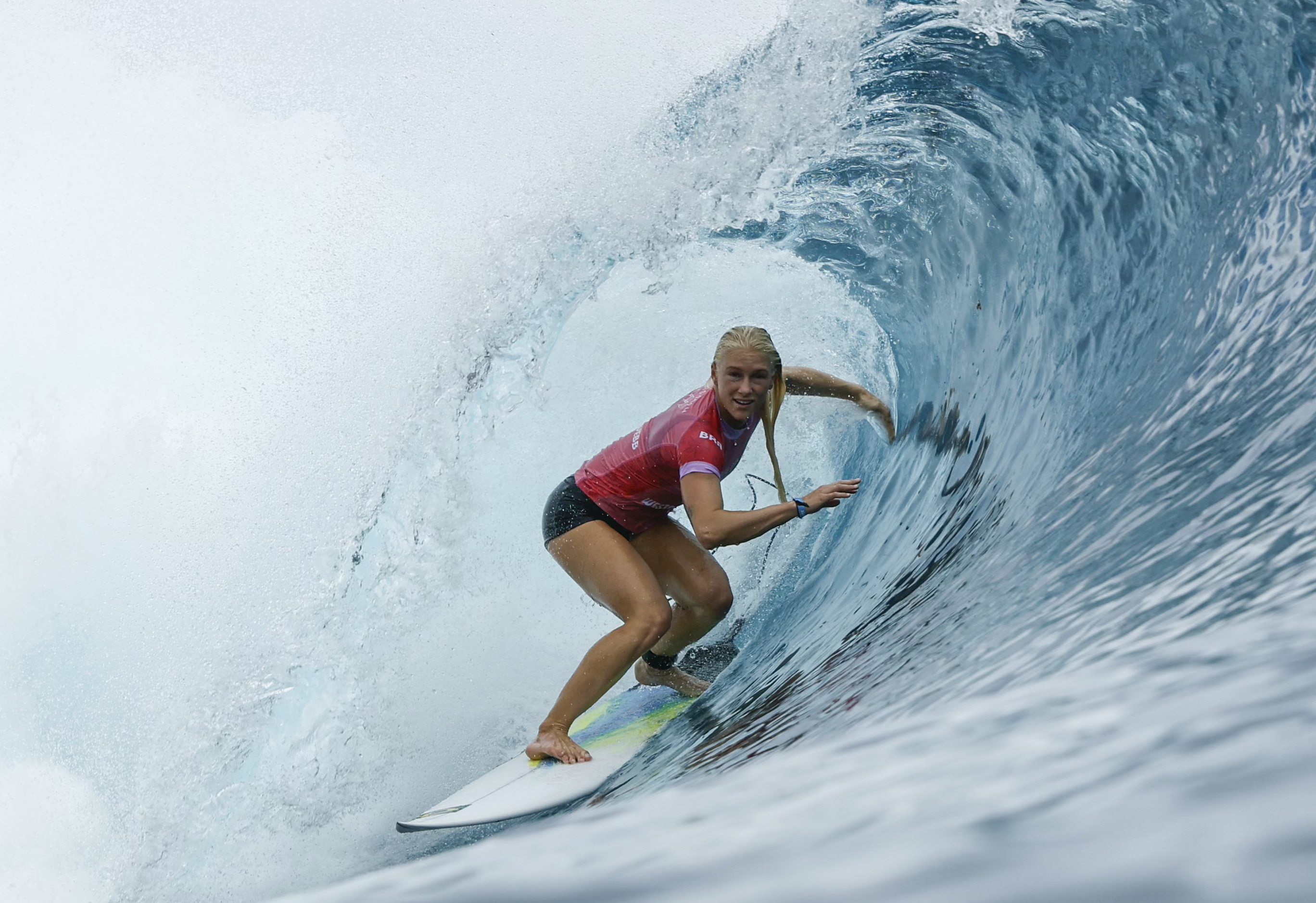 Tatiana Weston-Webb, of Brazil, gets into a barrel during the first round of the 2024 Summer Olympics surfing competition Saturday, July 27, 2024, in Teahupo'o, Tahiti. 