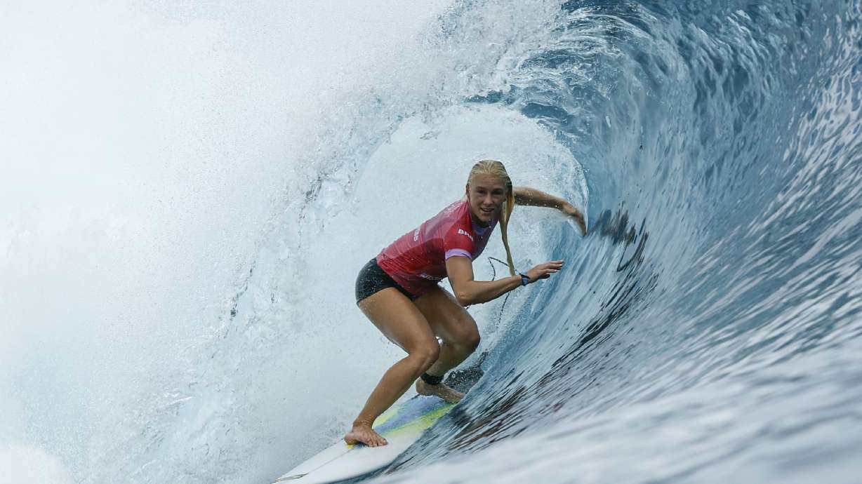Tatiana Weston-Webb, of Brazil, gets into a barrel during the first round of the 2024 Summer Olympics surfing competition Saturday, July 27, 2024, in Teahupo'o, Tahiti.