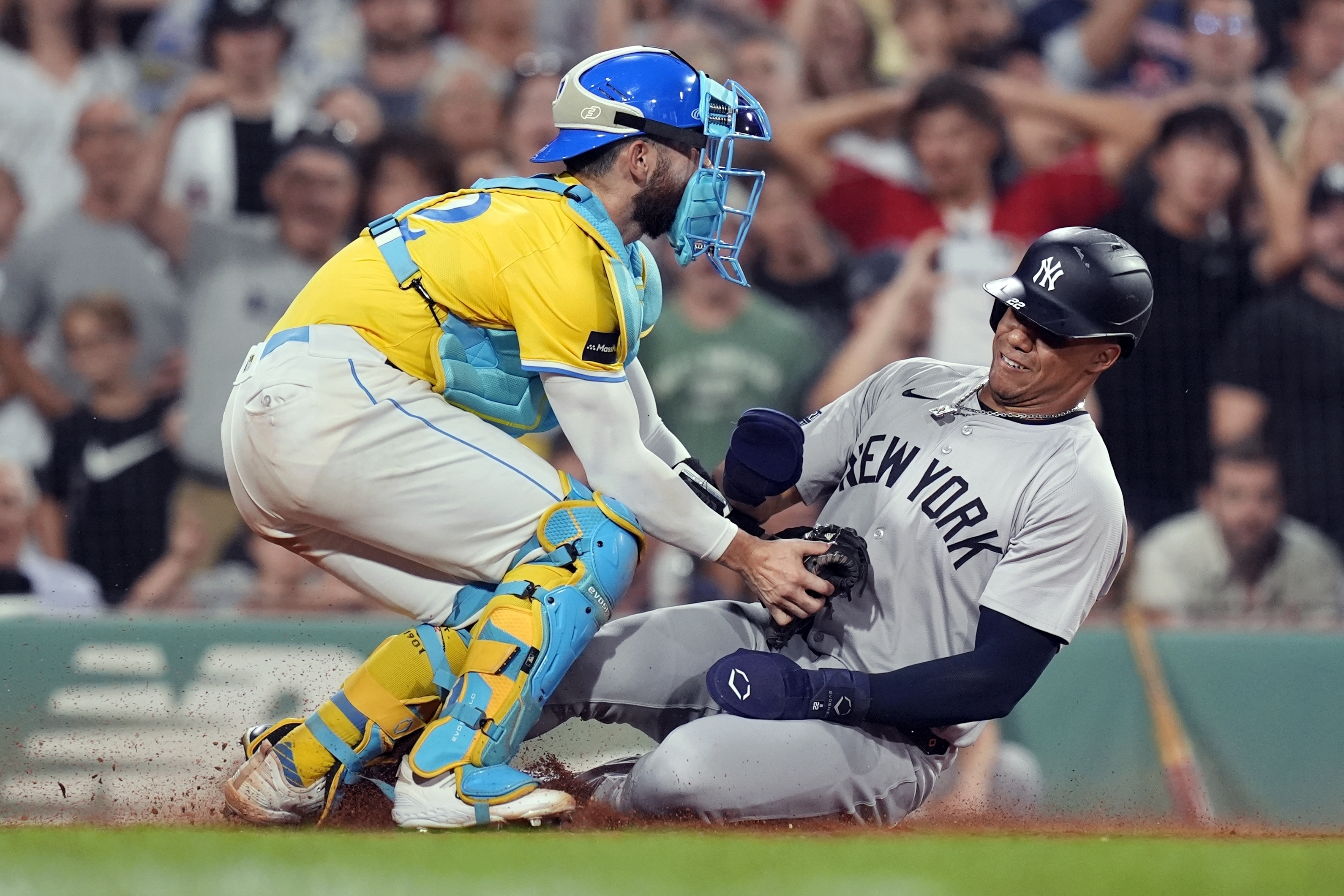 Boston Red Sox catcher Connor Wong, left, tags New York Yankees' Juan Soto trying to score on a double by Aaron Judge during the eighth inning of a baseball game, Saturday, July 27, 2024, in Boston. 