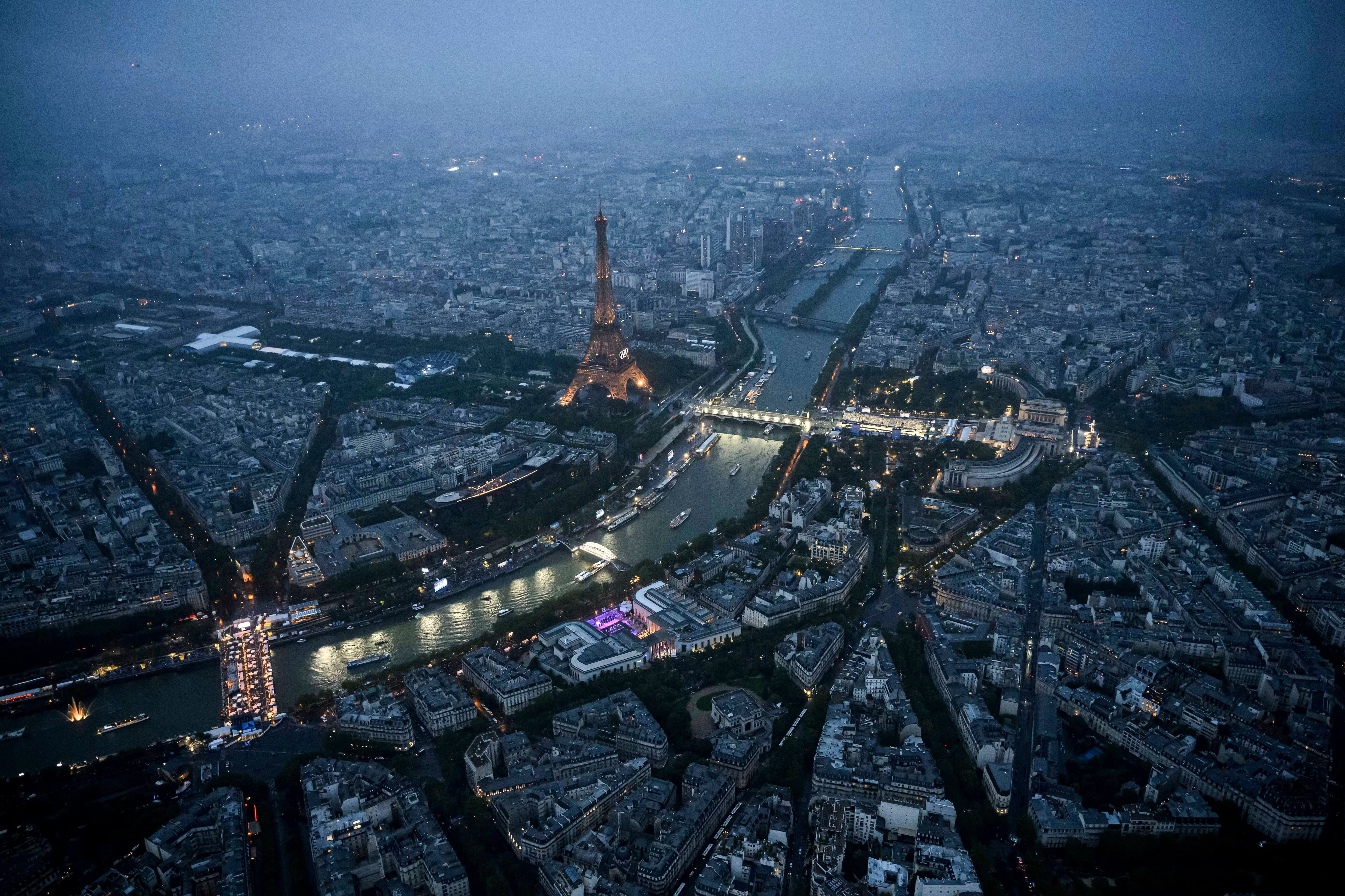 Delegation boats navigate various teams past the Eiffel Tower along the Seine in Paris, France, during the opening ceremony for the 2024 Summer Olympics, Friday.