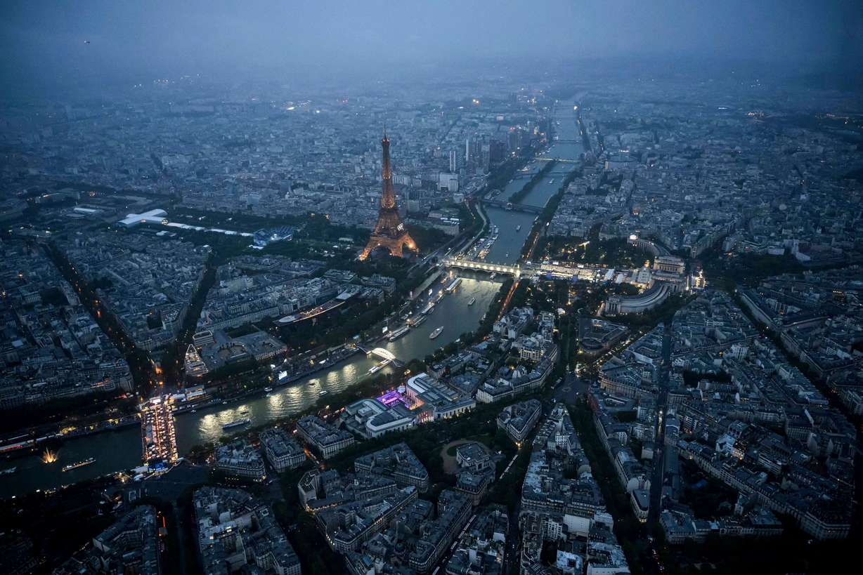 Delegation boats navigate various teams past the Eiffel Tower along the Seine in Paris, France, during the opening ceremony for the 2024 Summer Olympics, Friday.