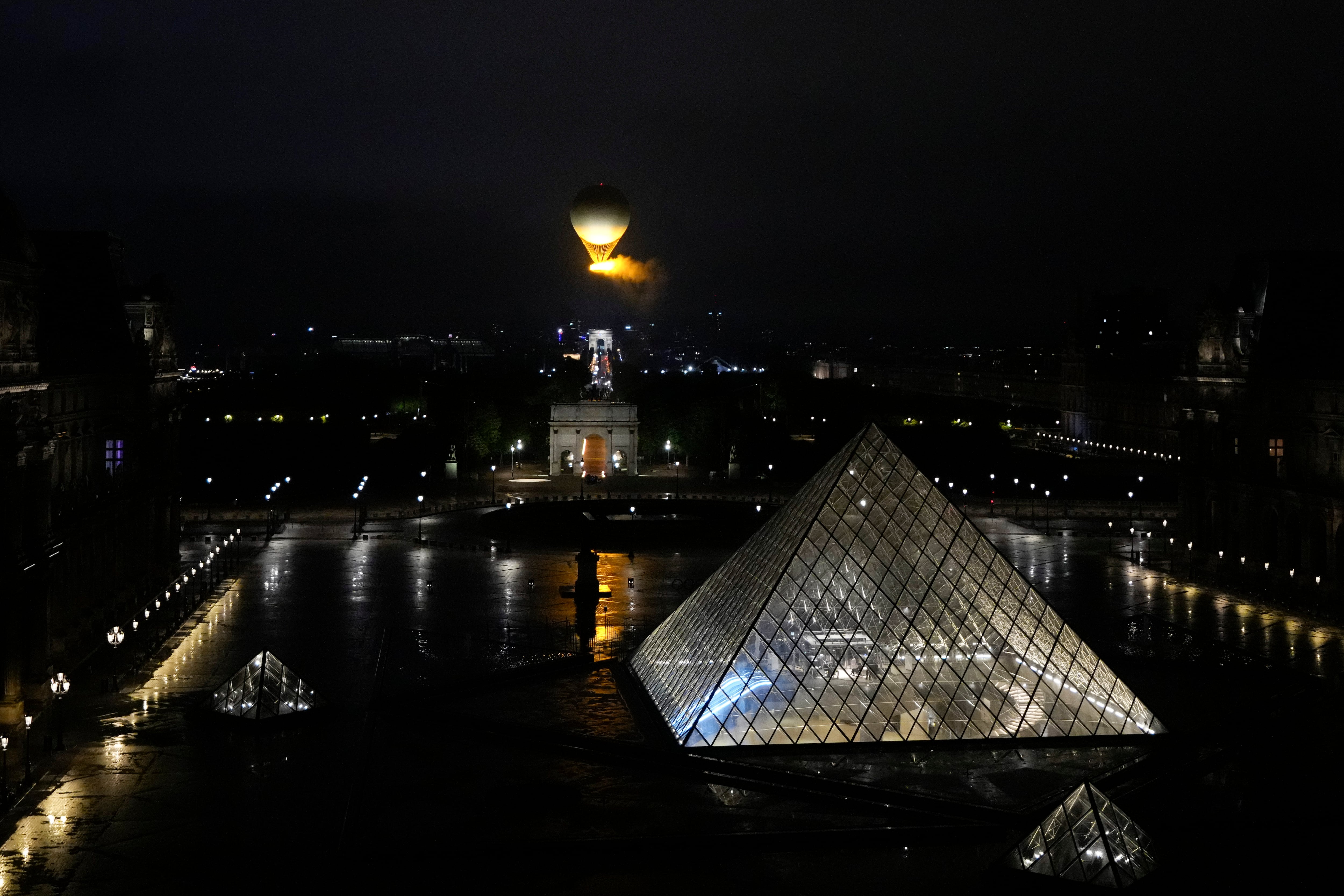 The cauldron, with the Olympic flame lit, lifts off while attached to a balloon, during the opening ceremony for the 2024 Summer Olympics in Paris, France, Friday.