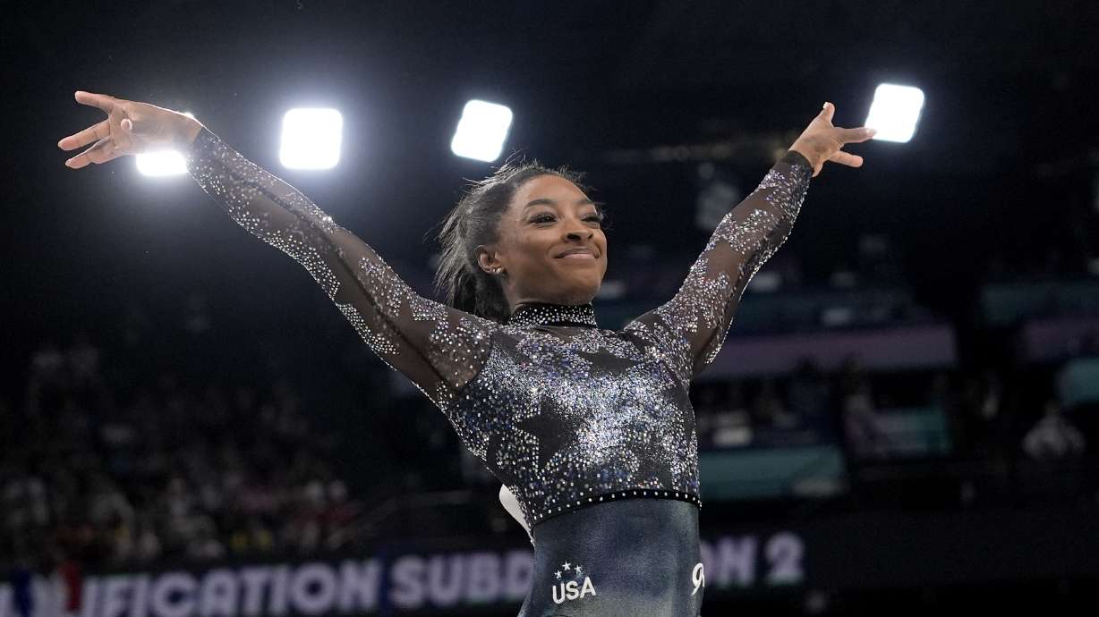 Simone Biles, of United States, smiles after competing on the vault during a women's artistic gymnastics qualification round at Bercy Arena at the 2024 Summer Olympics, Sunday, July 28, 2024, in Paris, France.