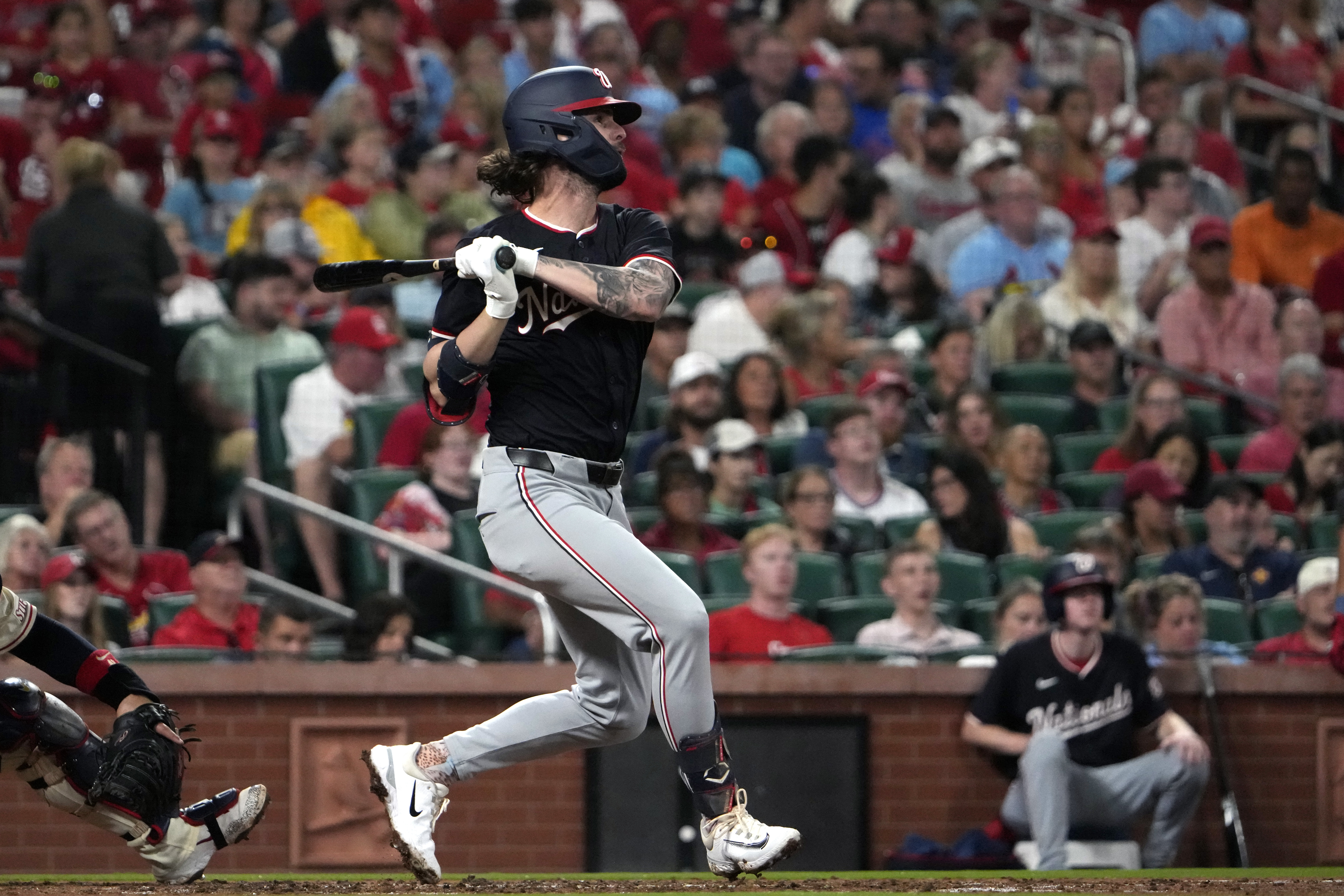 Washington Nationals' Jesse Winker hits an RBI single during the third inning of a baseball game against the St. Louis Cardinals Saturday, July 27, 2024, in St. Louis. 