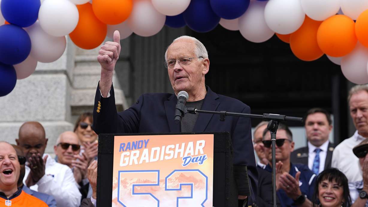 FILE - Denver Broncos Ring of Fame linebacker Randy Gradishar, center, speaks during a celebration outside the State Capitol to mark his inclusion in the NFL Pro Football Hall of Fame Class of 2024, Friday, May 3, 2024, in Denver. Gradishar is the first member of the Broncos' famed “Orange Crush” defense to be enshrined in the Pro Football Hall of Fame.