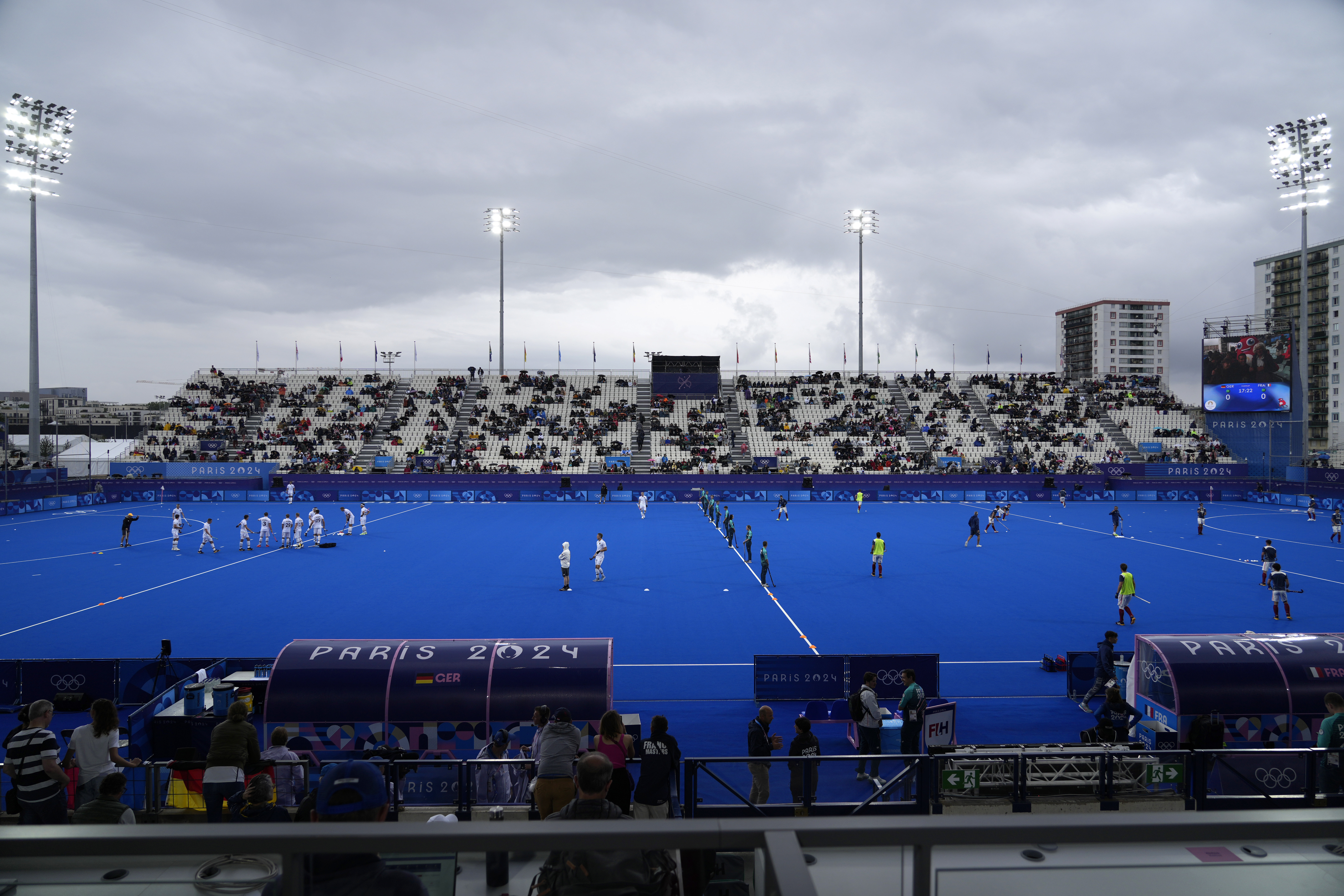 Players from Germany, left, and France field hockey teams warmup prior to their match at the Yves-du-Manoir Stadium, at the 2024 Summer Olympics, Saturday, July 27, 2024, in Colombes, France. 