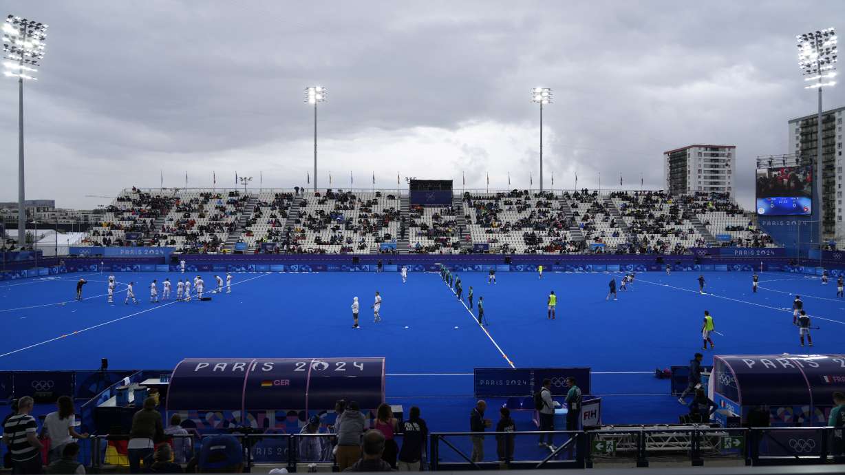 Players from Germany, left, and France field hockey teams warmup prior to their match at the Yves-du-Manoir Stadium, at the 2024 Summer Olympics, Saturday, July 27, 2024, in Colombes, France.