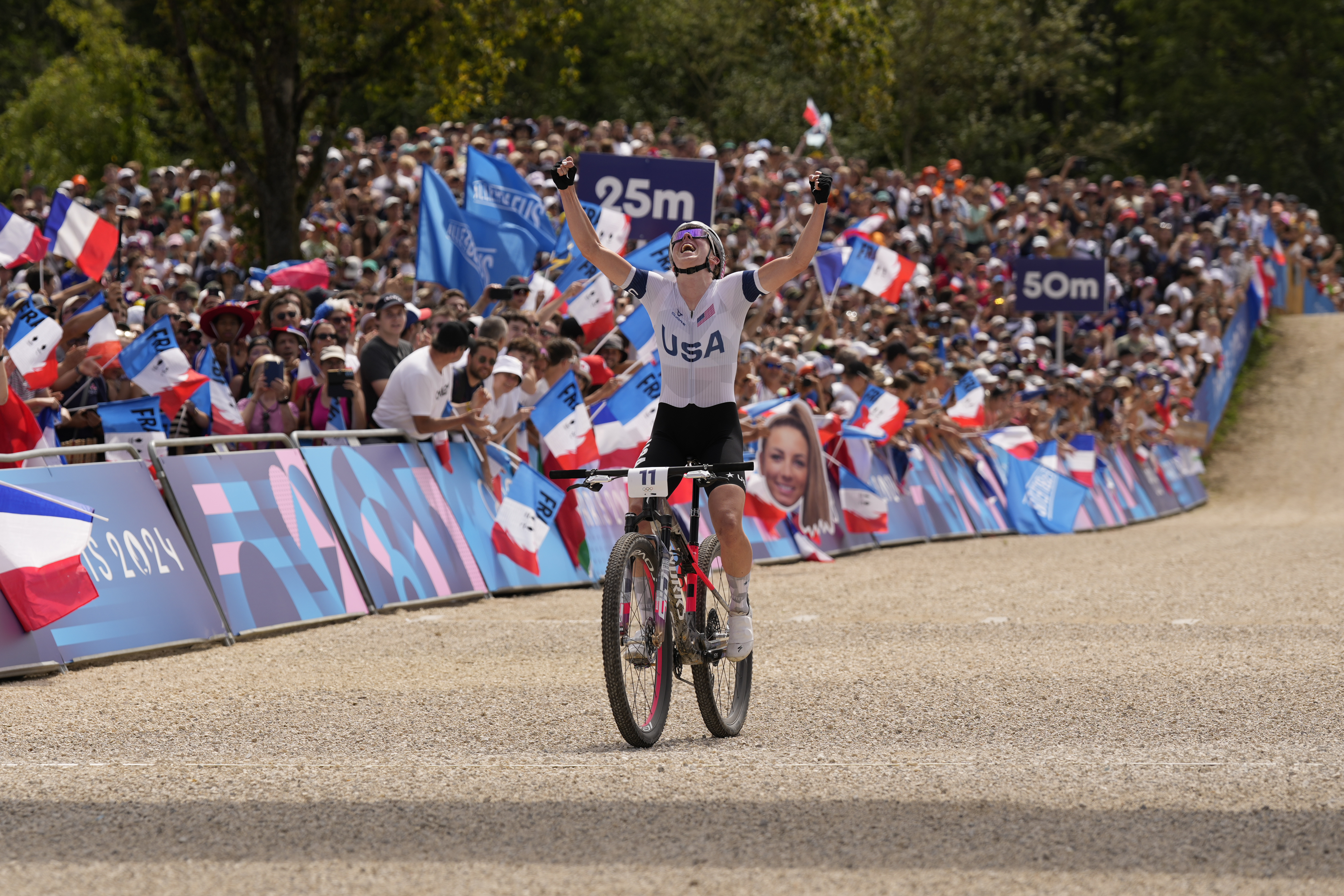 Haley Batten, of United States, celebrates her second place in the women's mountain bike cycling event, at the 2024 Summer Olympics, Sunday, July 28, 2024, in Elancourt, France. 