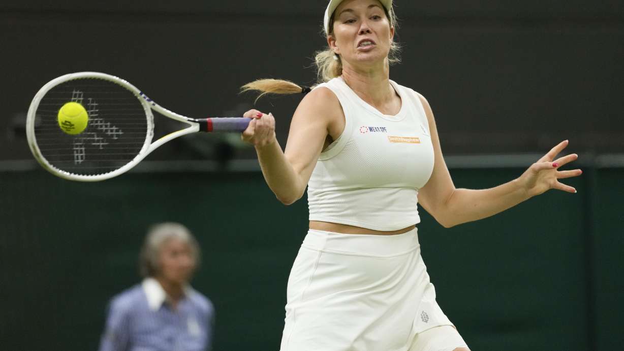 Danielle Collins plays a forehand return to Barbora Krejcikova of the Czech Republic during their fourth round match at the Wimbledon tennis championships in London, Monday, July 8, 2024.