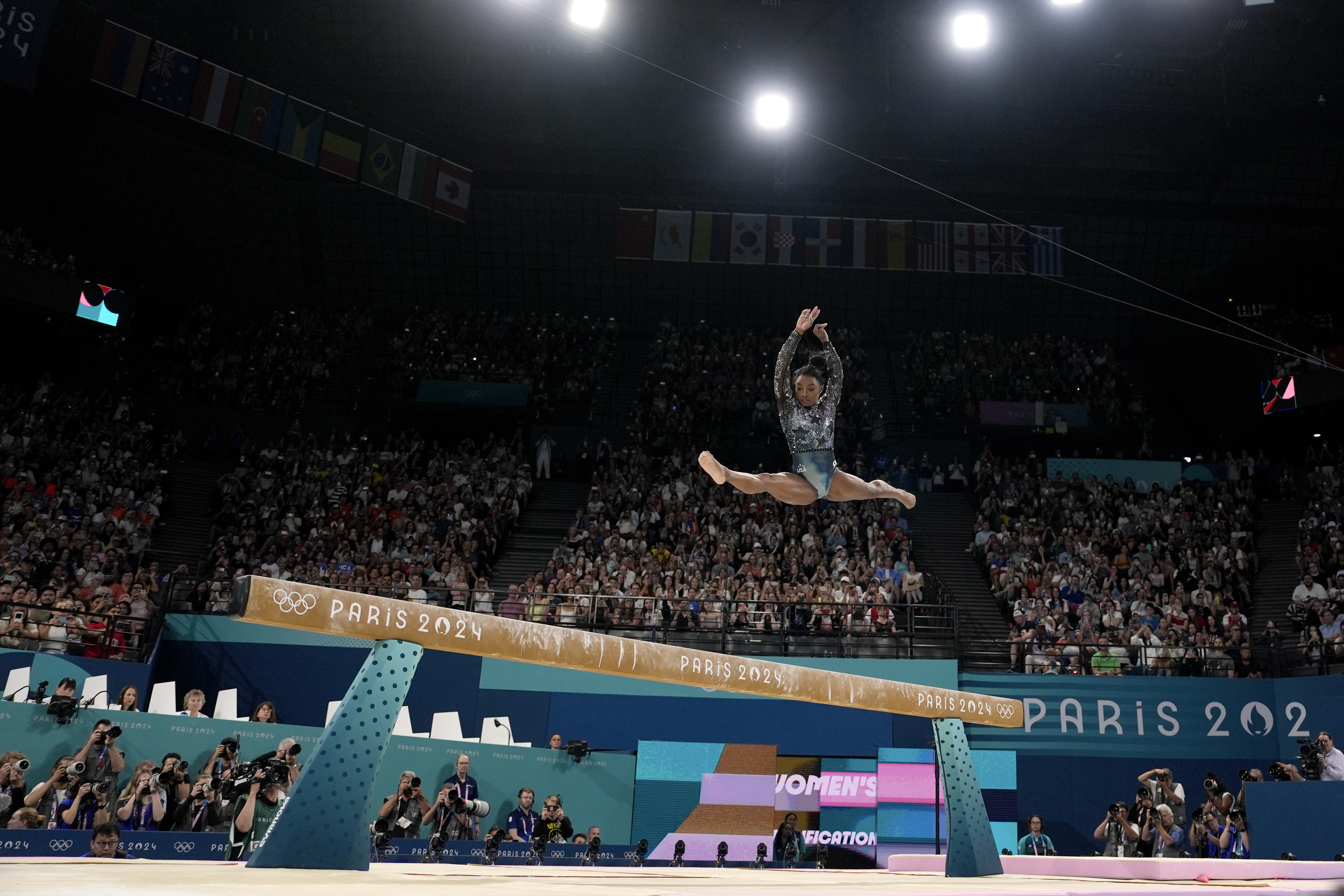Simone Biles of the United States competes on the balance beam during a women's artistic gymnastics qualification round at the 2024 Summer Olympics, Sunday, July 28, 2024, in Paris, France.