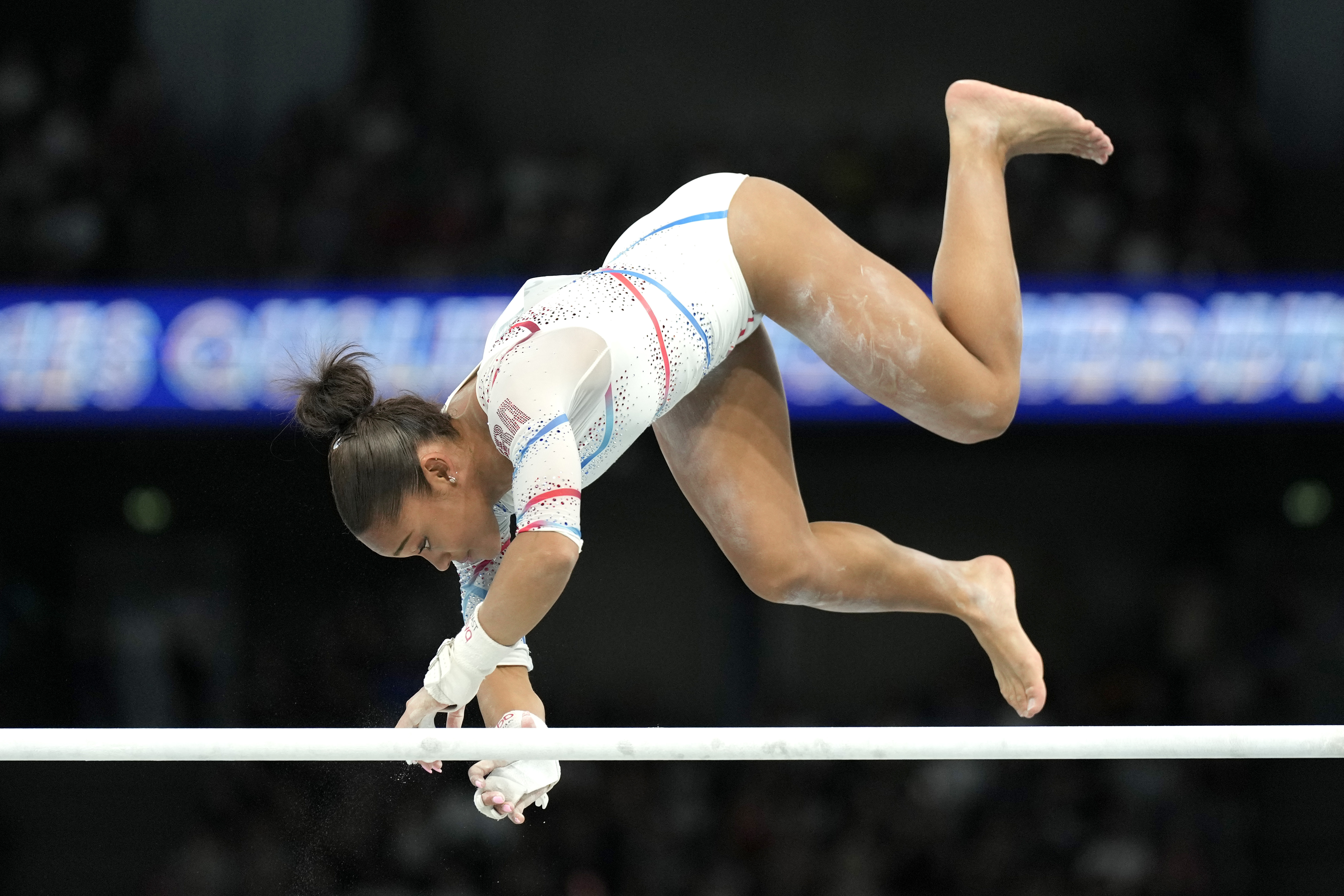 Melanie dos Santos de Jesus, of France, falls off of the uneven bars during a women's artistic gymnastics qualification round at Bercy Arena at the 2024 Summer Olympics, Sunday, July 28, 2024, in Paris, France.