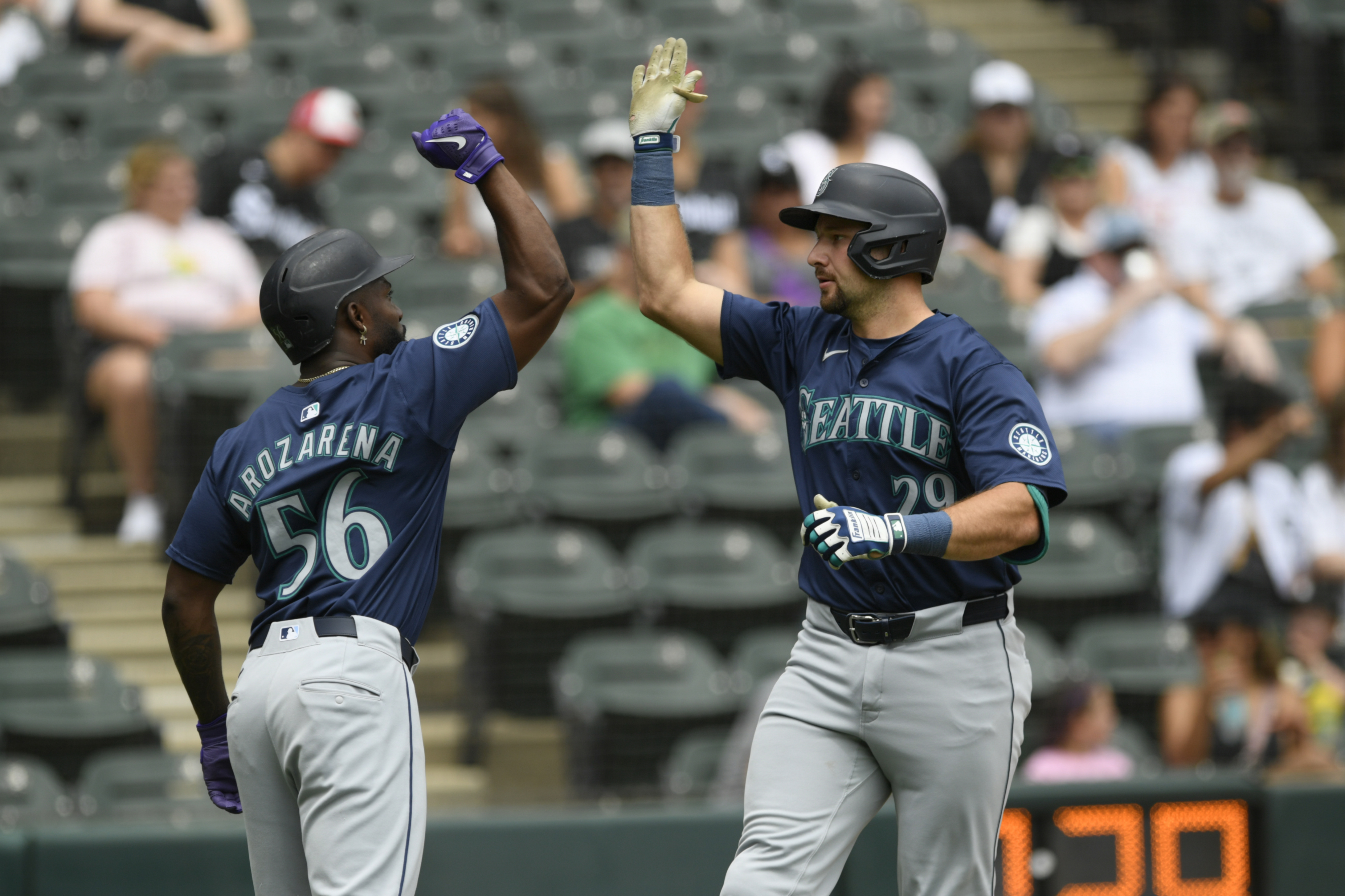 Seattle Mariners' Cal Raleigh (29) celebrates with teammate Randy Arozarena (56) after hitting a two-run home run during the first inning of a baseball game against the Chicago White Sox in Chicago, Sunday, July 28, 2024. 