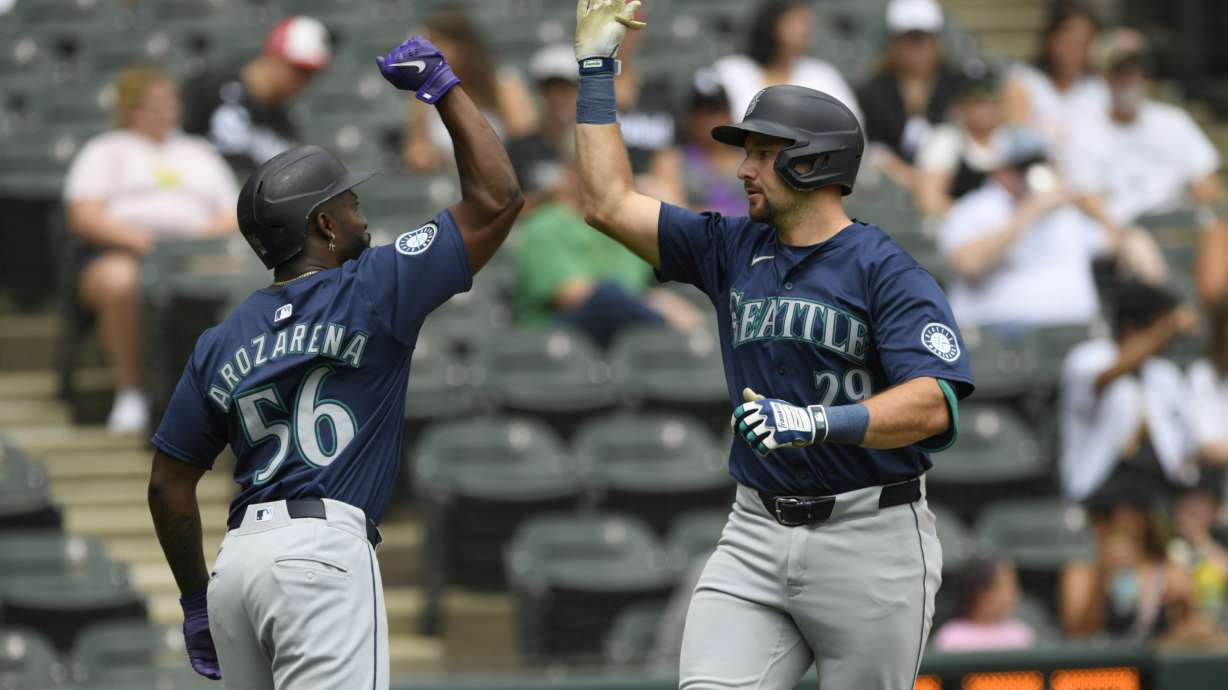 Seattle Mariners' Cal Raleigh (29) celebrates with teammate Randy Arozarena (56) after hitting a two-run home run during the first inning of a baseball game against the Chicago White Sox in Chicago, Sunday, July 28, 2024.