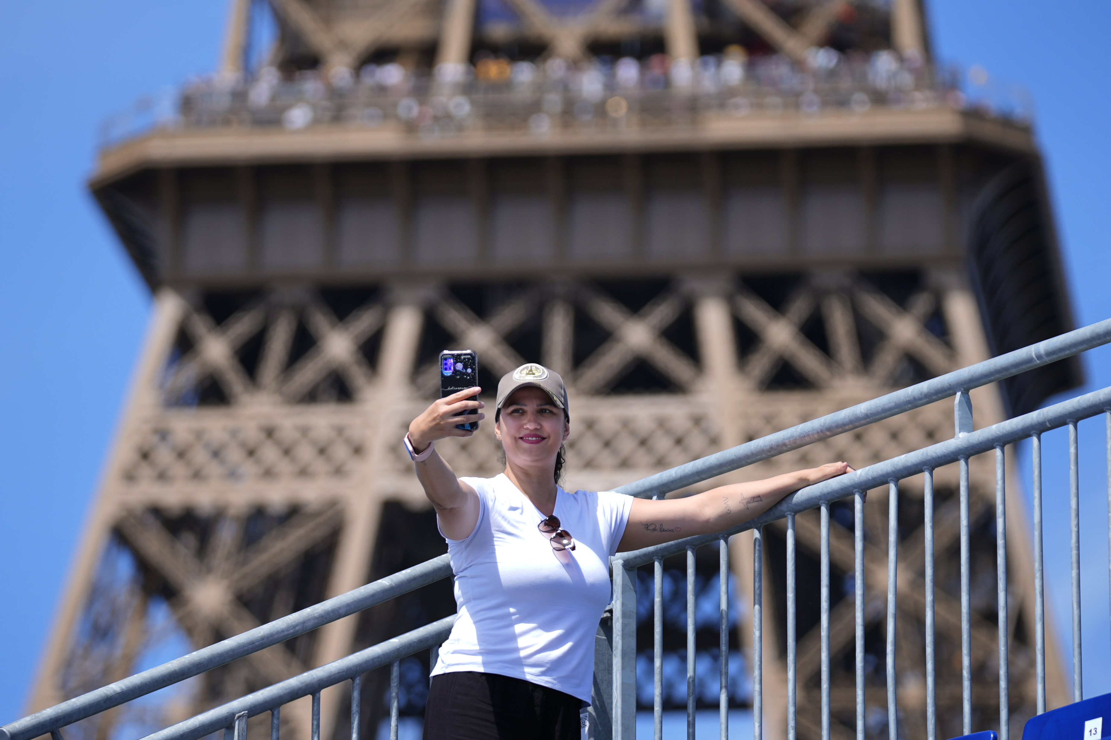 Katia Souza of Brazil takes a selfie from Eiffel Tower Stadium after a beach volleyball match at the 2024 Summer Olympics, Sunday, July 28, 2024, in Paris, France. 
