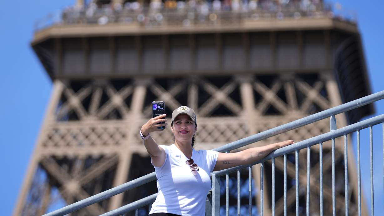 Katia Souza of Brazil takes a selfie from Eiffel Tower Stadium after a beach volleyball match at the 2024 Summer Olympics, Sunday, July 28, 2024, in Paris, France.
