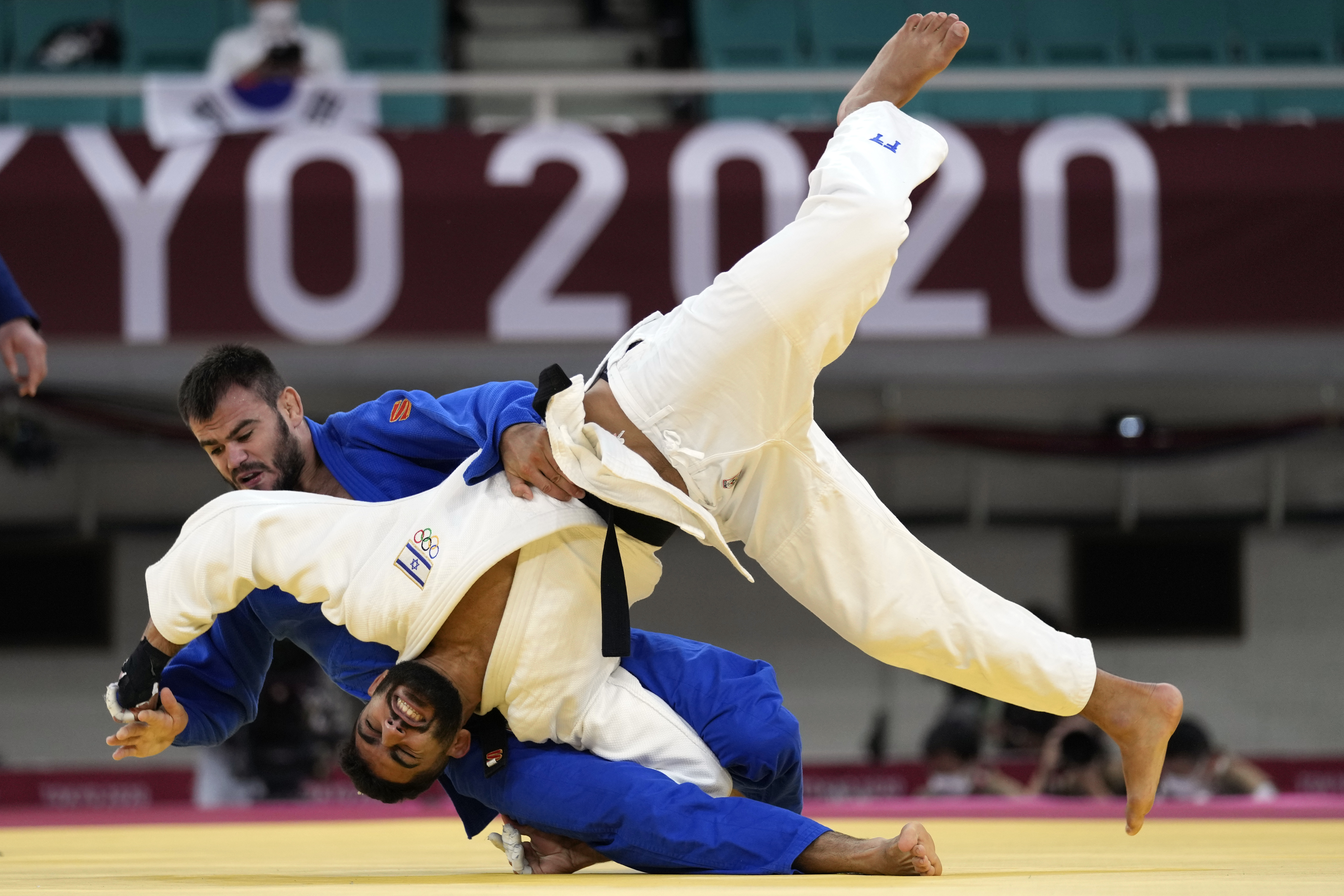 FILE - Victor Sterpu of Moldova, background and Tohar Butbul of Israel compete during their men's -73kg round of 16 judo match at the 2020 Summer Olympics in Tokyo, Japan, Monday, July 26, 2021. 