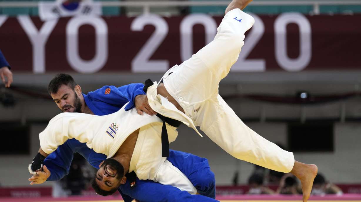 FILE - Victor Sterpu of Moldova, background and Tohar Butbul of Israel compete during their men's -73kg round of 16 judo match at the 2020 Summer Olympics in Tokyo, Japan, Monday, July 26, 2021.