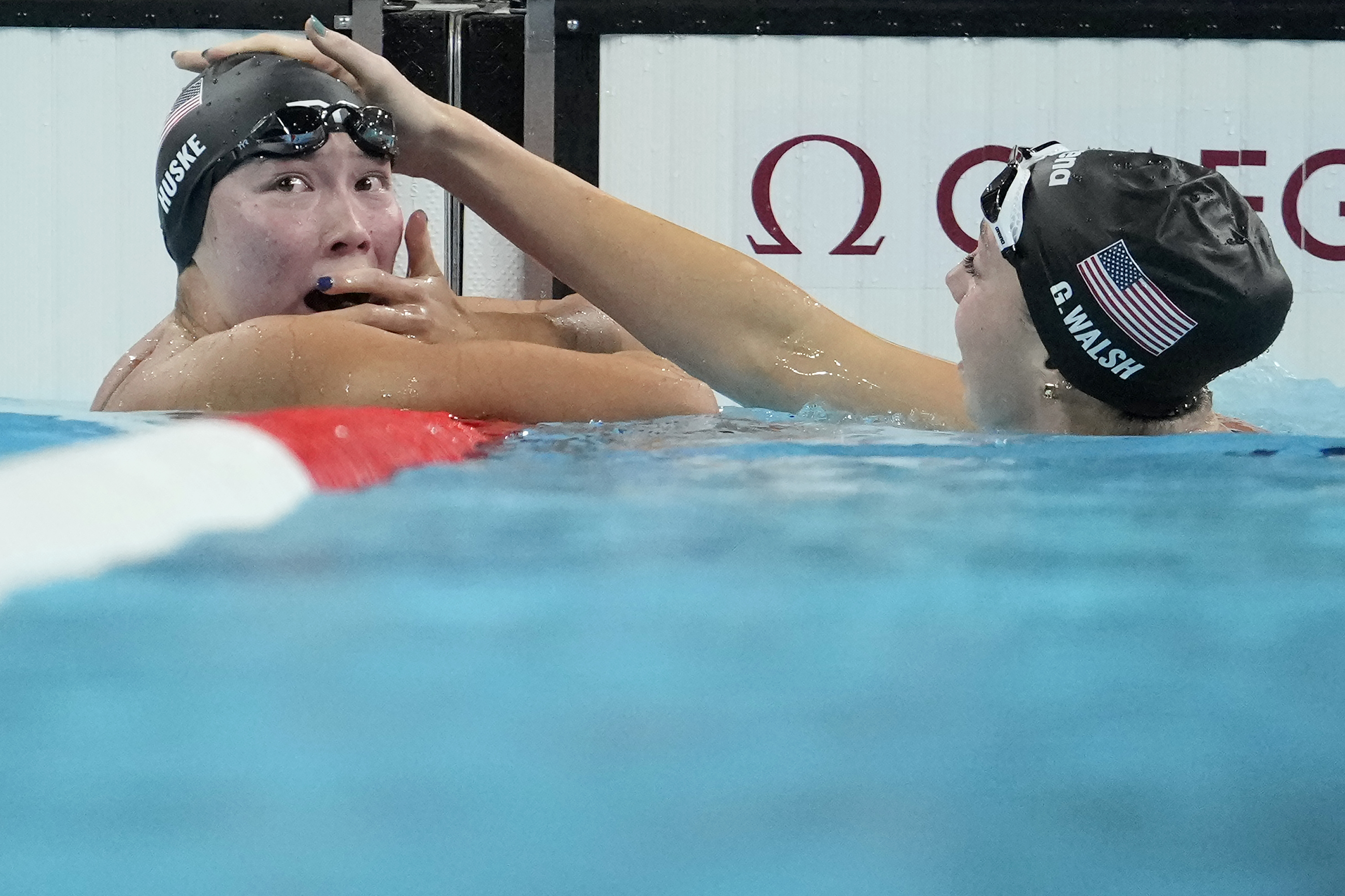 Torri Huske, left, of the United States, reacts after winning the women's 100-meter butterfly final with teammate Gretchen Walsh at the 2024 Summer Olympics, Sunday, July 28, 2024, in Nanterre, France. 