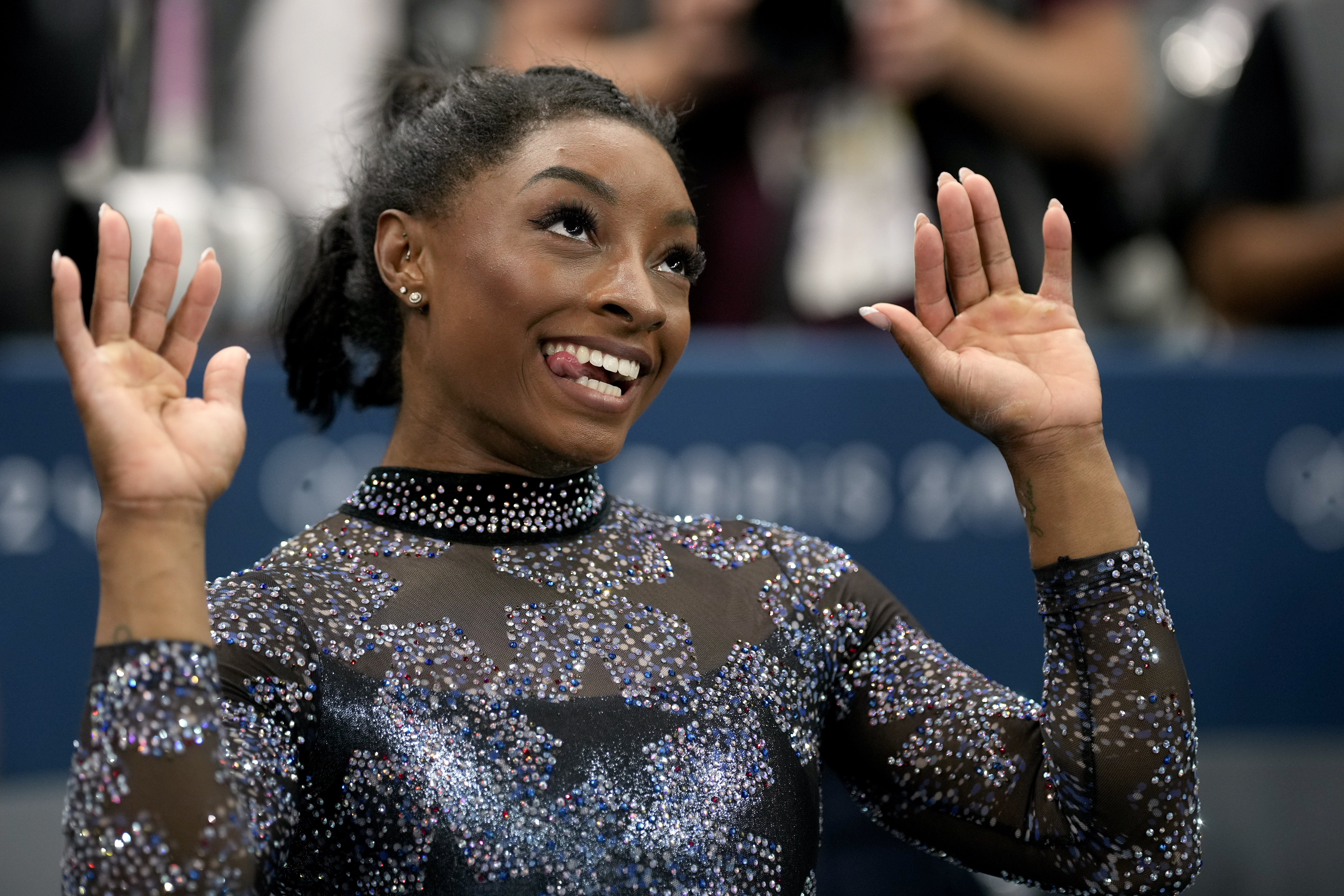 Simone Biles, of United States, celebrates after competing on the uneven bars during a women's artistic gymnastics qualification round at Bercy Arena at the 2024 Summer Olympics, Sunday, July 28, 2024, in Paris, France. 
