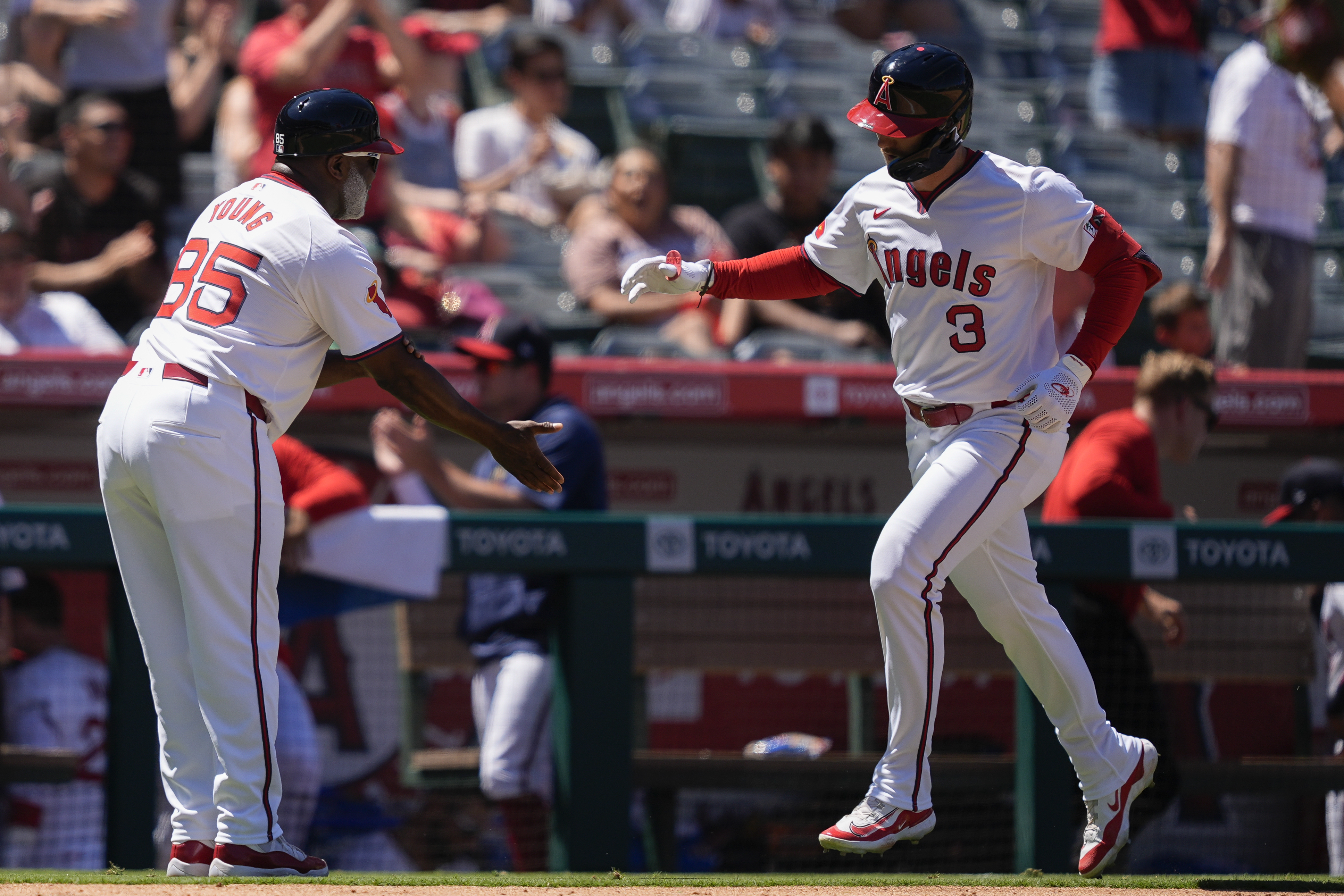 Los Angeles Angels' Taylor Ward (3) celebrates his grand slam with third base coach Eric Young Sr. during the fourth inning of a baseball game against the Oakland Athletics, Sunday, July 28, 2024, in Anaheim, Calif. 