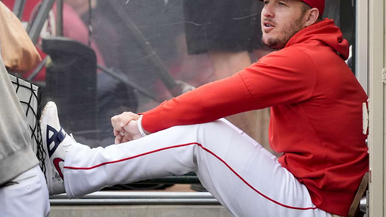 FILE - Los Angeles Angels center fielder Mike Trout sits in the dugout during the second inning of a baseball game against the Houston Astros, June 7, 2024, in Anaheim, Calif. Trout has said an MRI on his left knee came back clean and that he is hoping to resume his rehab soon.