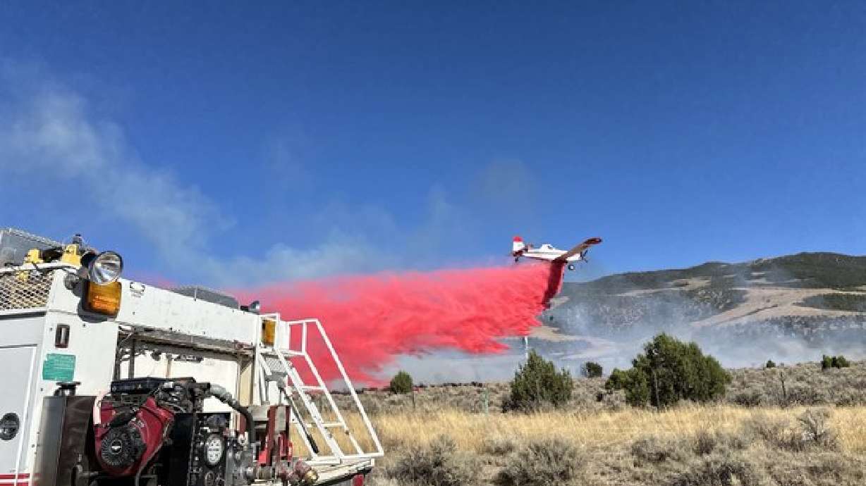 Crews work to extinguish the Tank Fire near I-15 in southern Utah on Sunday. It has burned about 25 acres as of Monday, according to Utah Fire Info.