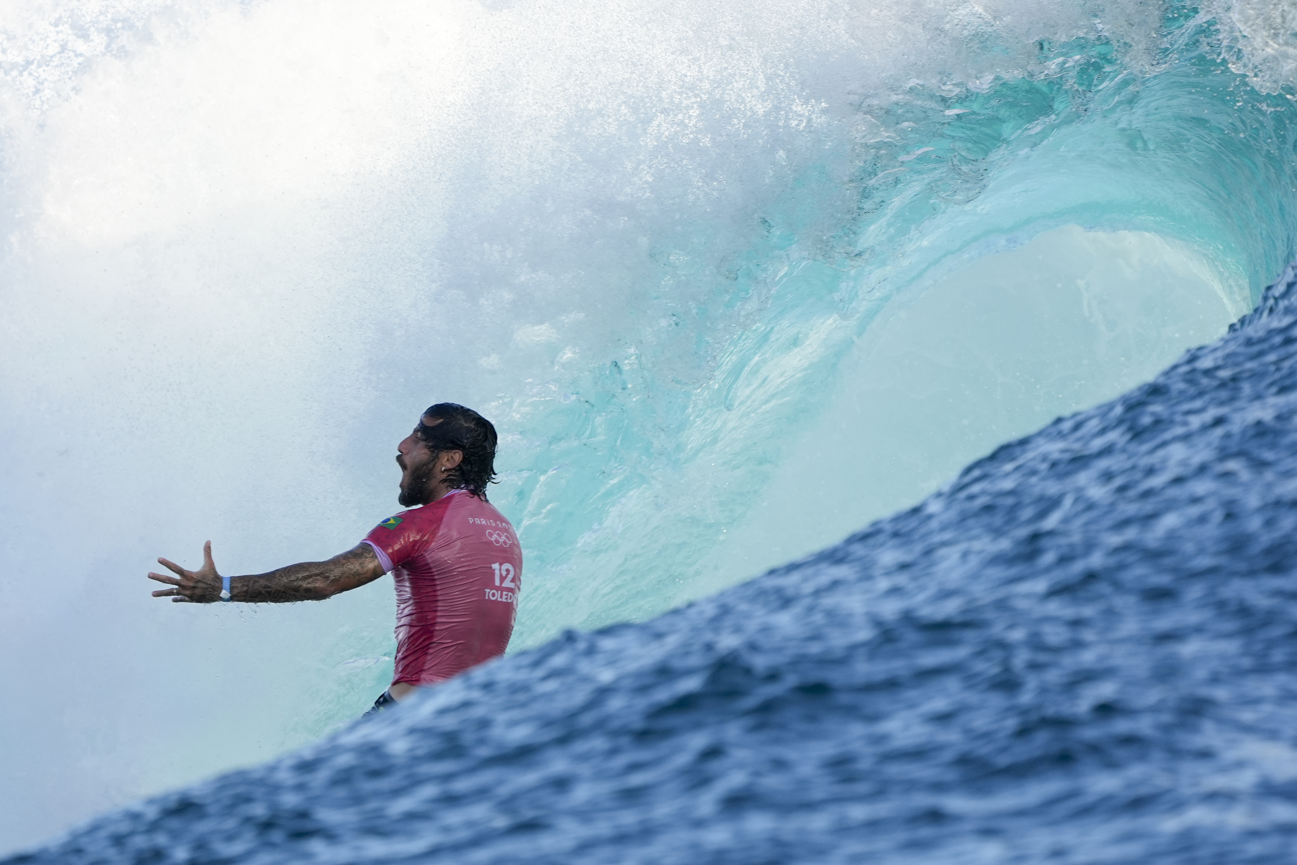 Filipe Toledo, of Brazil, celebrates after a run during the second round of the 2024 Summer Olympics surfing competition Sunday, July 28, 2024, in Teahupo'o, Tahiti. 