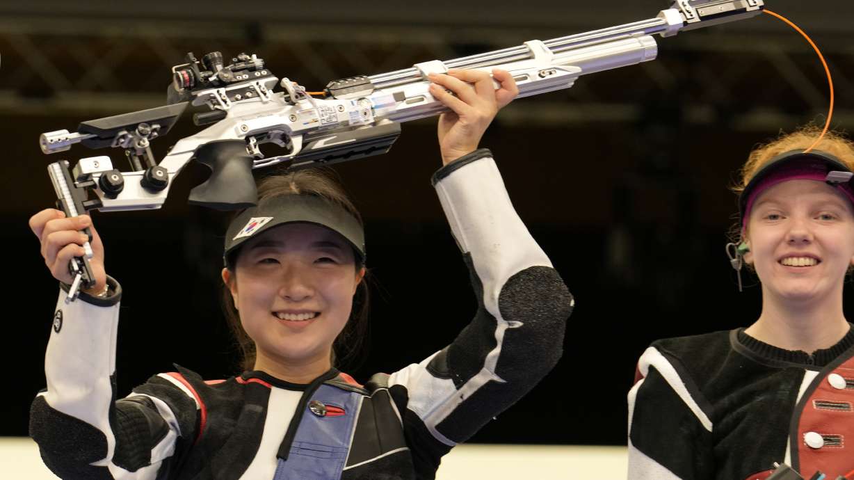 South Korea's Ban Hyojin, left, celebrates after winning the 10m air rifle women's final as the third-place holder Switzerland's Audrey Gogniat looks on at the 2024 Summer Olympics, Monday, July 29, 2024, in Chateauroux, France.