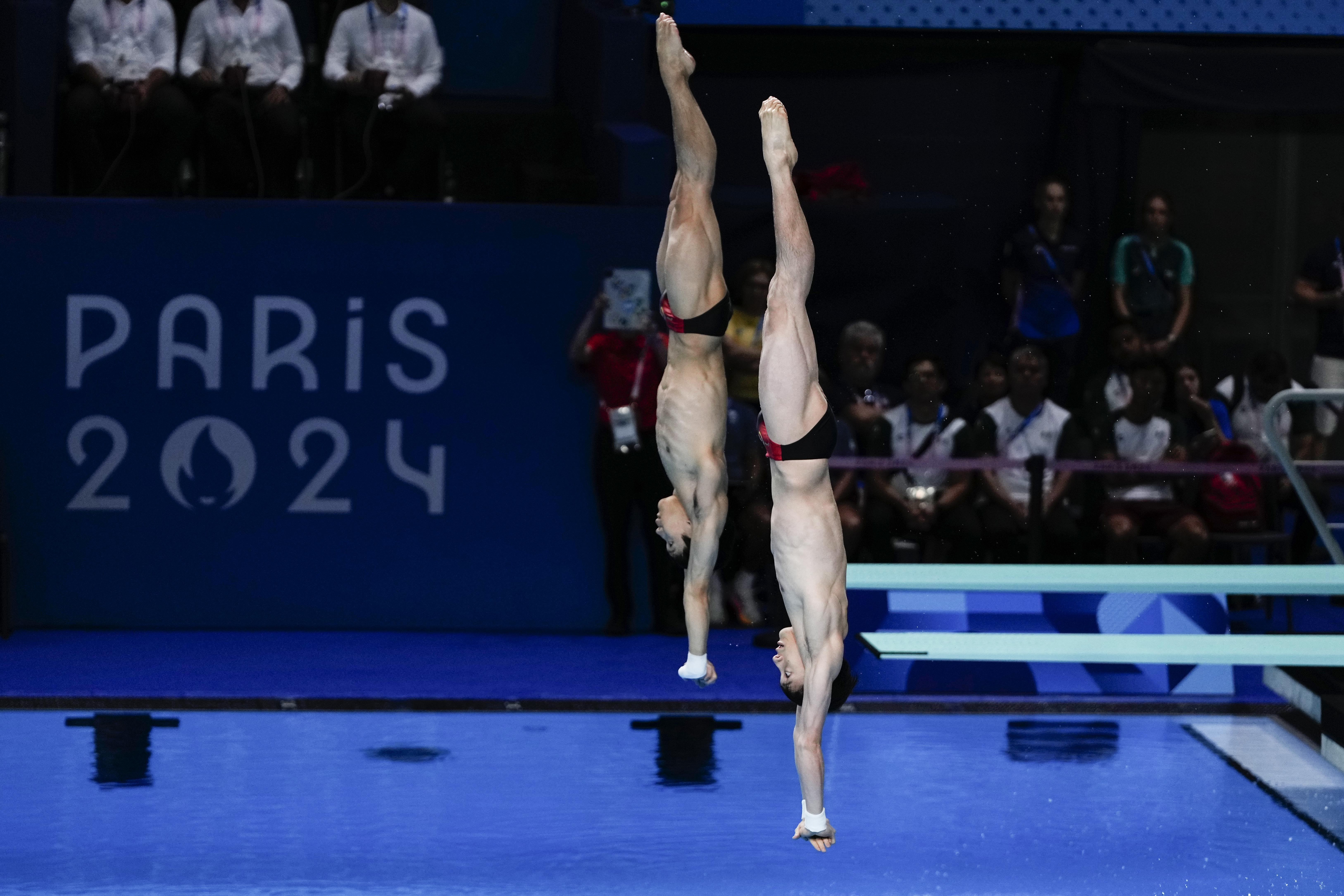 China's Lian Junjie and Yang Hao compete in the men's synchronised 10m springboard diving final at the 2024 Summer Olympics, Monday, July 29, 2024, in Saint-Denis, France. 
