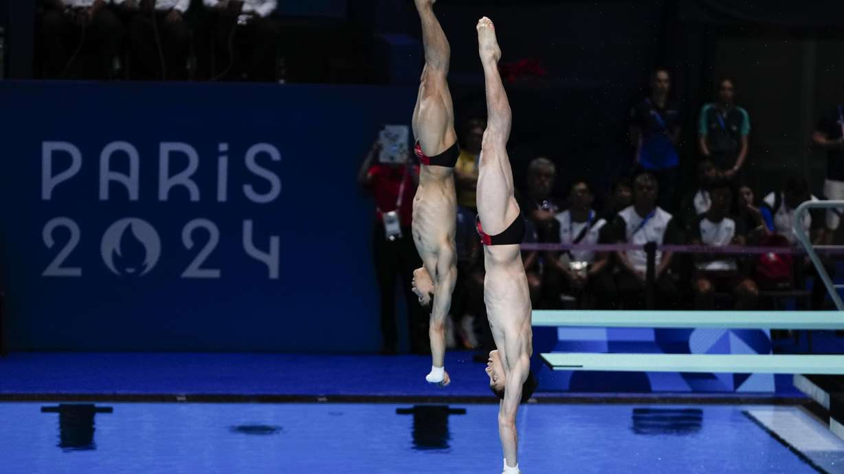 China's Lian Junjie and Yang Hao compete in the men's synchronised 10m springboard diving final at the 2024 Summer Olympics, Monday, July 29, 2024, in Saint-Denis, France.