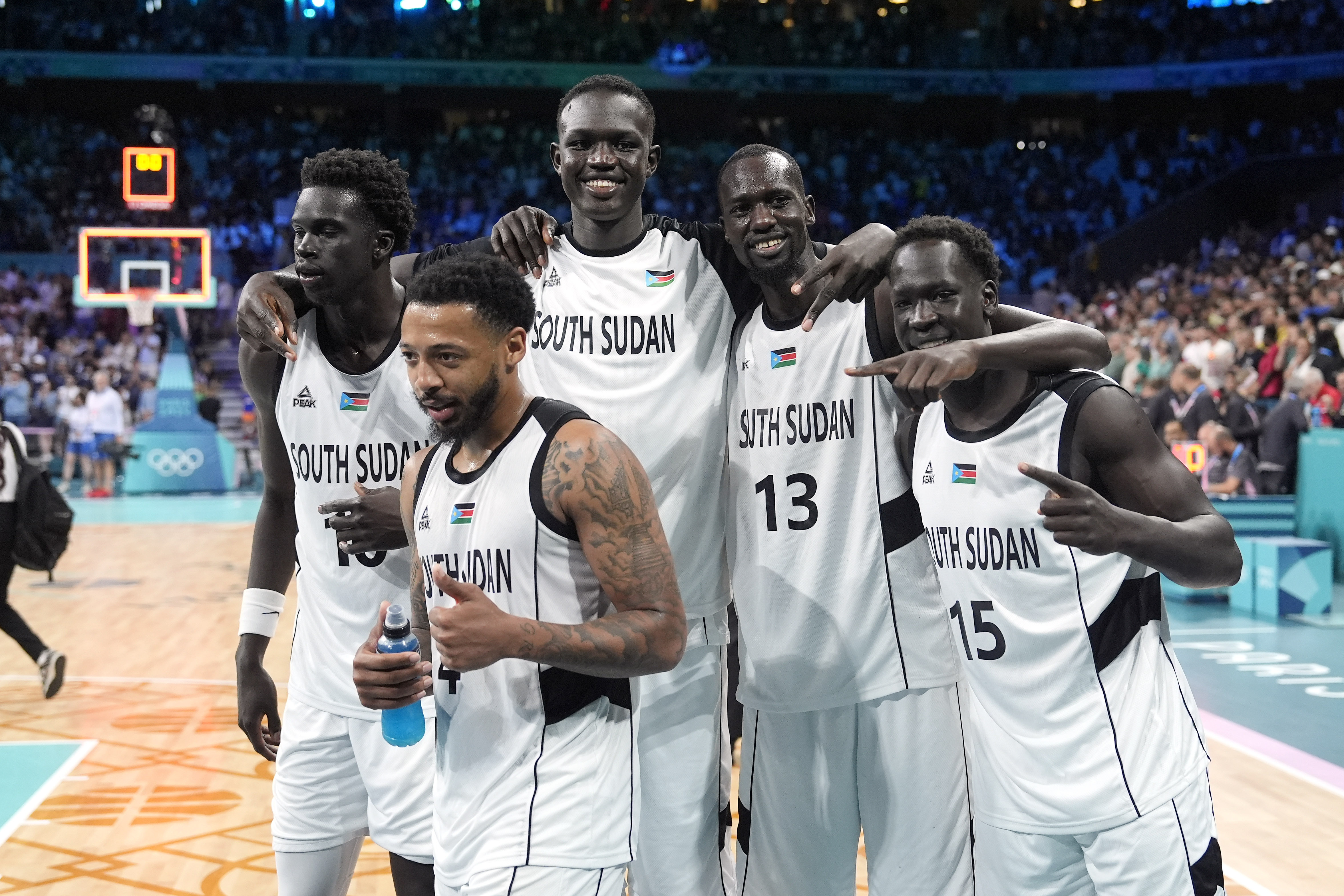 Members of the South Sudan team pose after they defeated Puerto Rico in a men's basketball game at the 2024 Summer Olympics, Sunday, July 28, 2024, in Villeneuve-d'Ascq, France. 