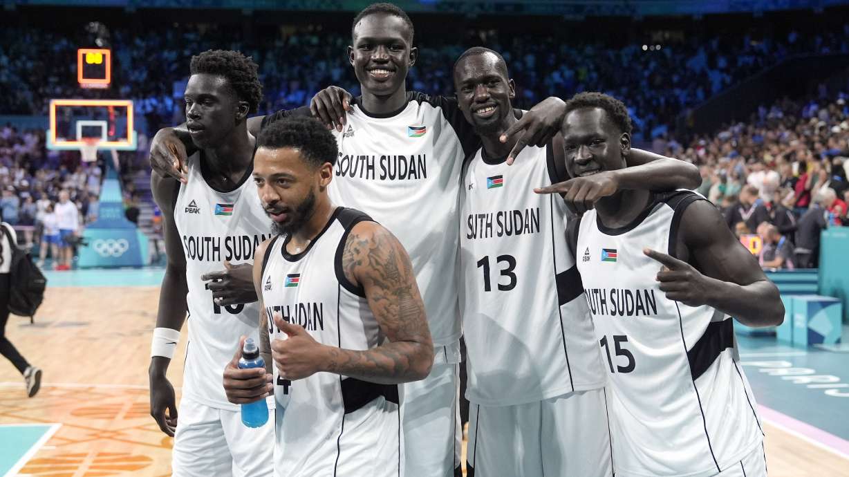 Members of the South Sudan team pose after they defeated Puerto Rico in a men's basketball game at the 2024 Summer Olympics, Sunday, July 28, 2024, in Villeneuve-d'Ascq, France.