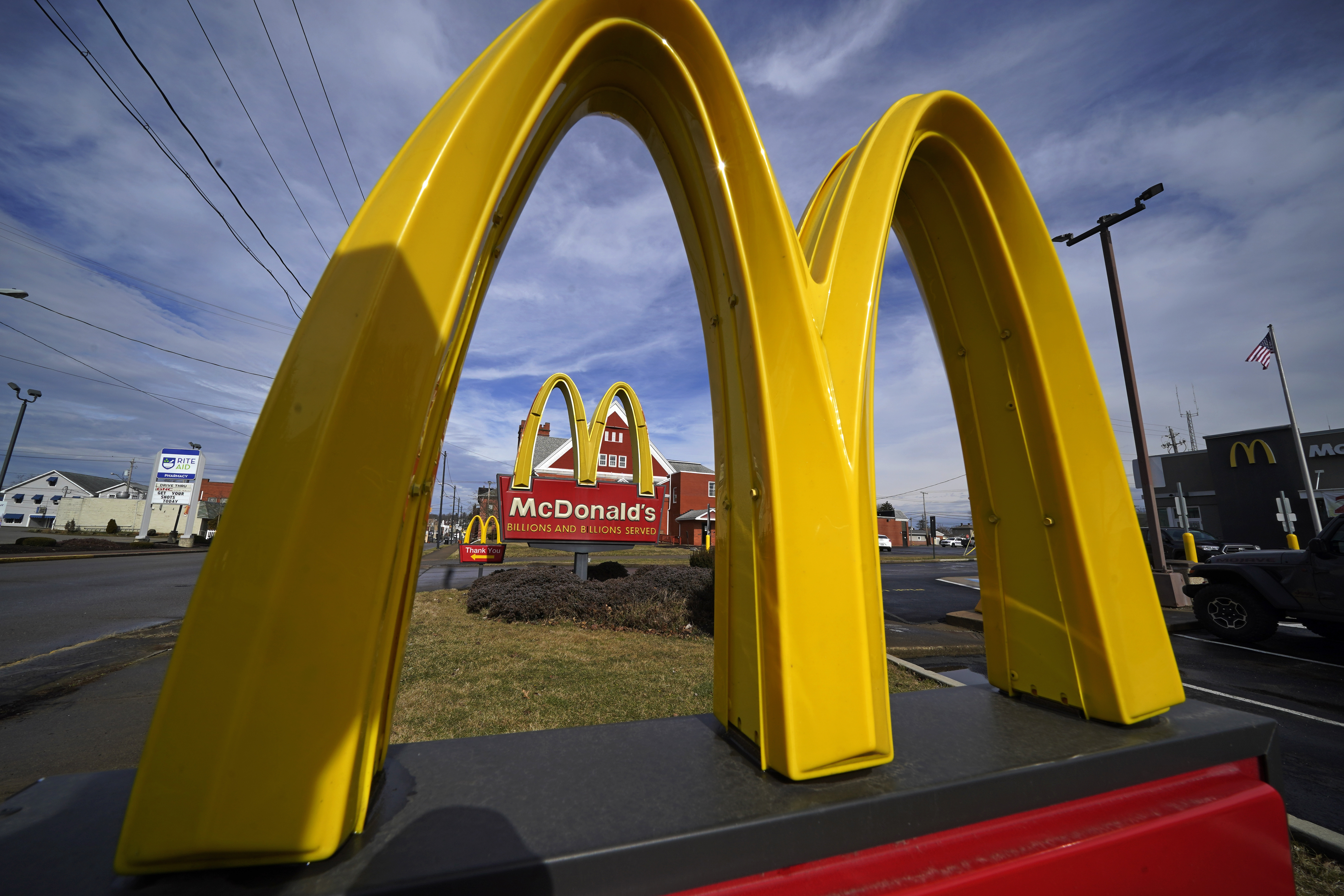 McDonald's reports sales at locations open at least a year fell 1% worldwide in the April-June period.
