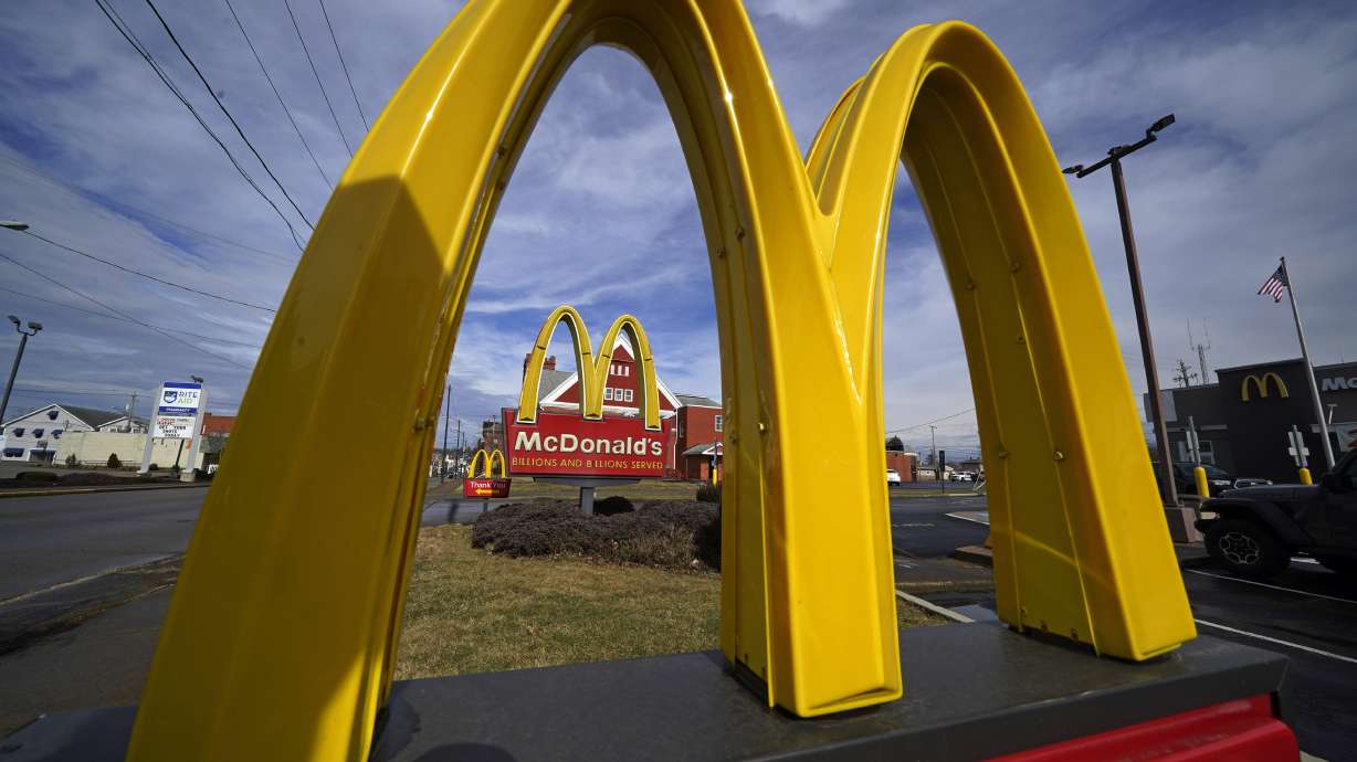 McDonald's reports sales at locations open at least a year fell 1% worldwide in the April-June period.
