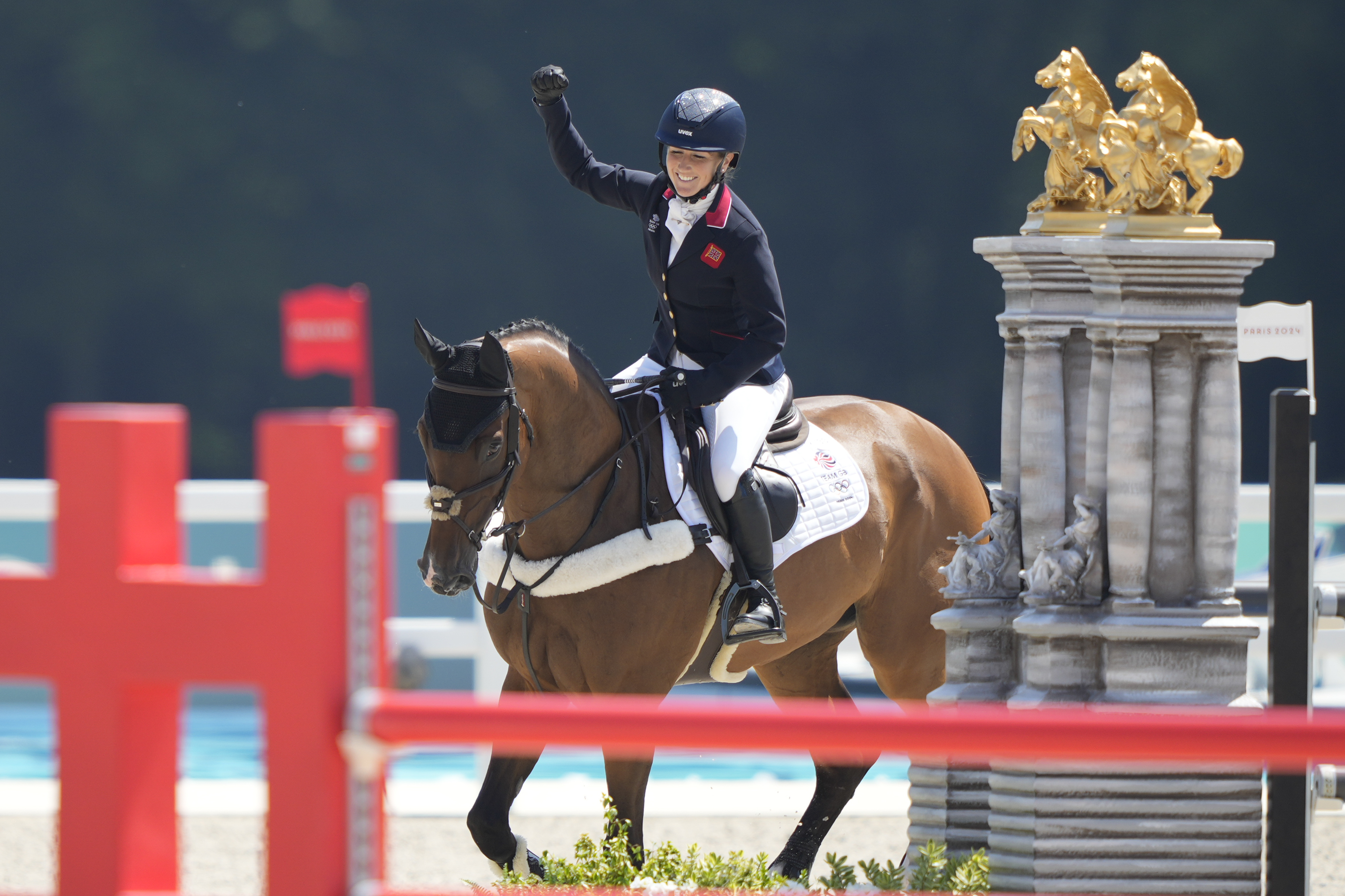Britain's Laura Collett, riding London 52, celebrates after winning the gold medal in the equestrian jumping teams competition at the 2024 Summer Olympics, Monday, July 29, 2024, in Versailles, France.