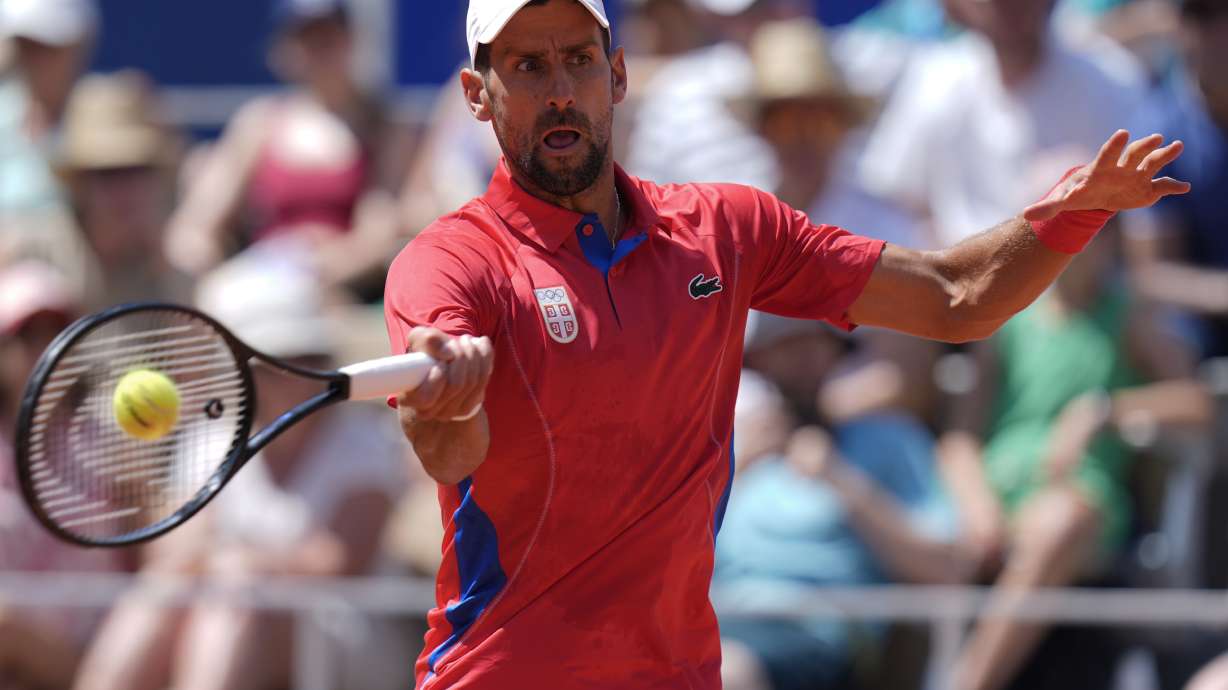 Serbia's Novak Djokovic returns the ball to Spain's Rafael Nadal during their men's singles second round match at the 2024 Summer Olympics, Monday, July 29, 2024, at the Roland Garros stadium in Paris, France.