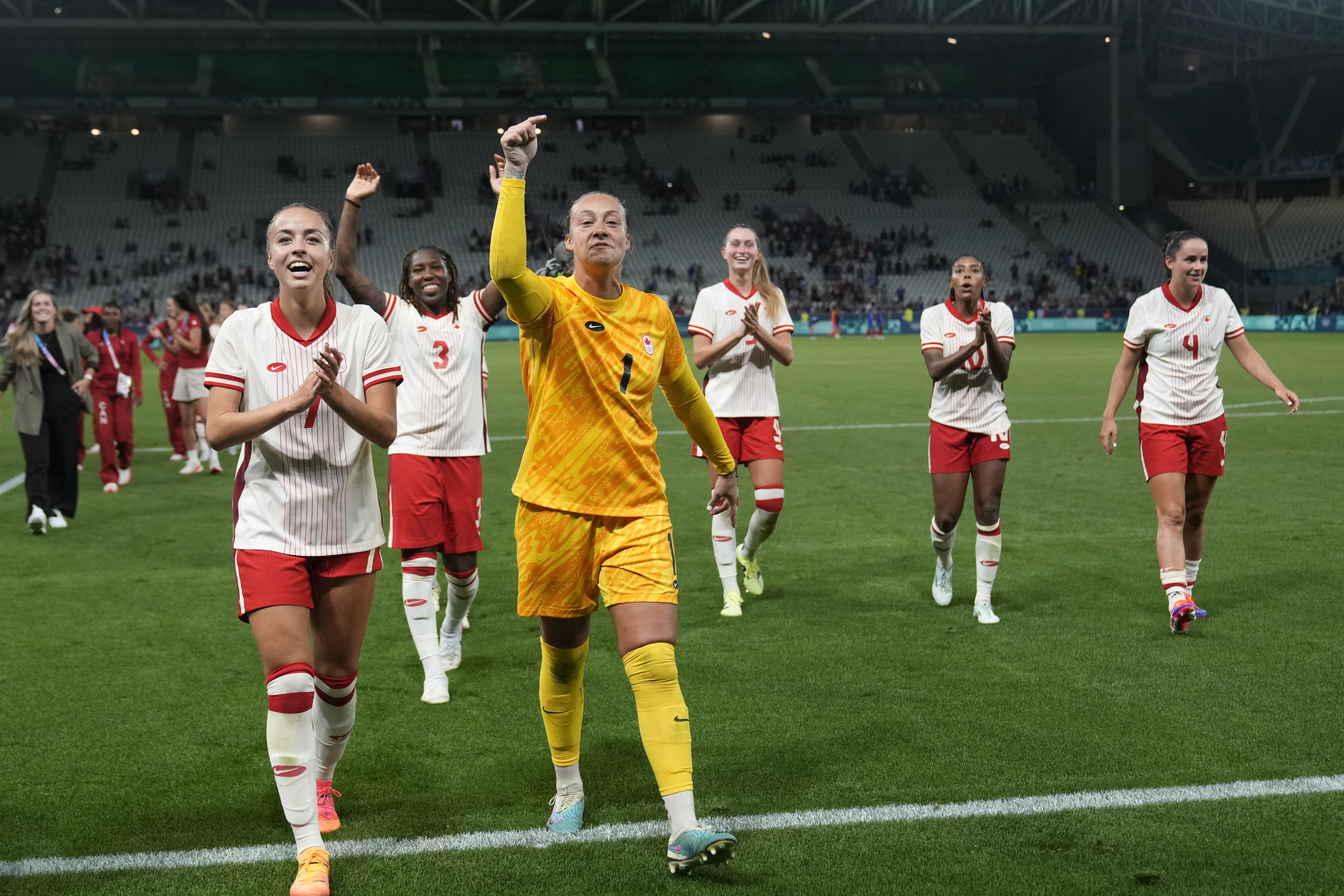 Canada team celebrates their side's 2-1 win at the end of the women's Group A soccer match between Canada and France at Geoffroy-Guichard stadium during the 2024 Summer Olympics, Sunday, July 28, 2024, in Saint-Etienne, France. 