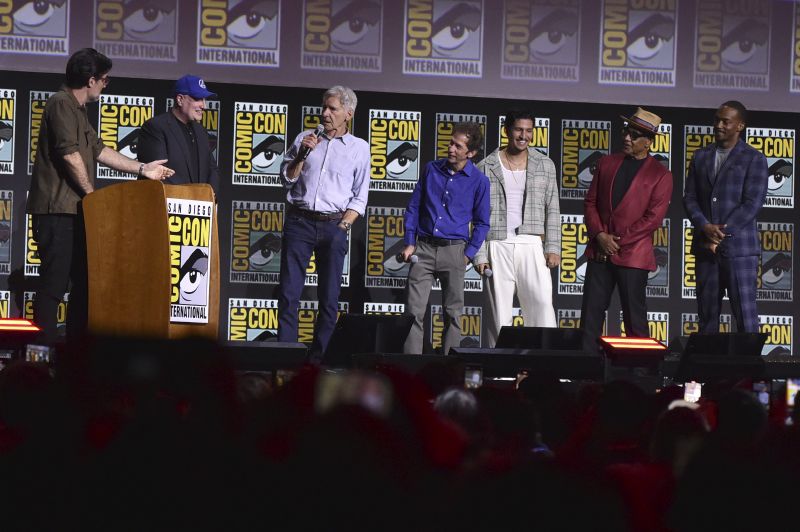 Rob Delaney, from left, Kevin Feige, Harrison Ford, Tim Blake Nelson, Danny Ramirez, Giancarlo Esposito, and Anthony Mackie attend a panel for "Marvel Studios" during Comic-Con International on Saturday in San Diego.