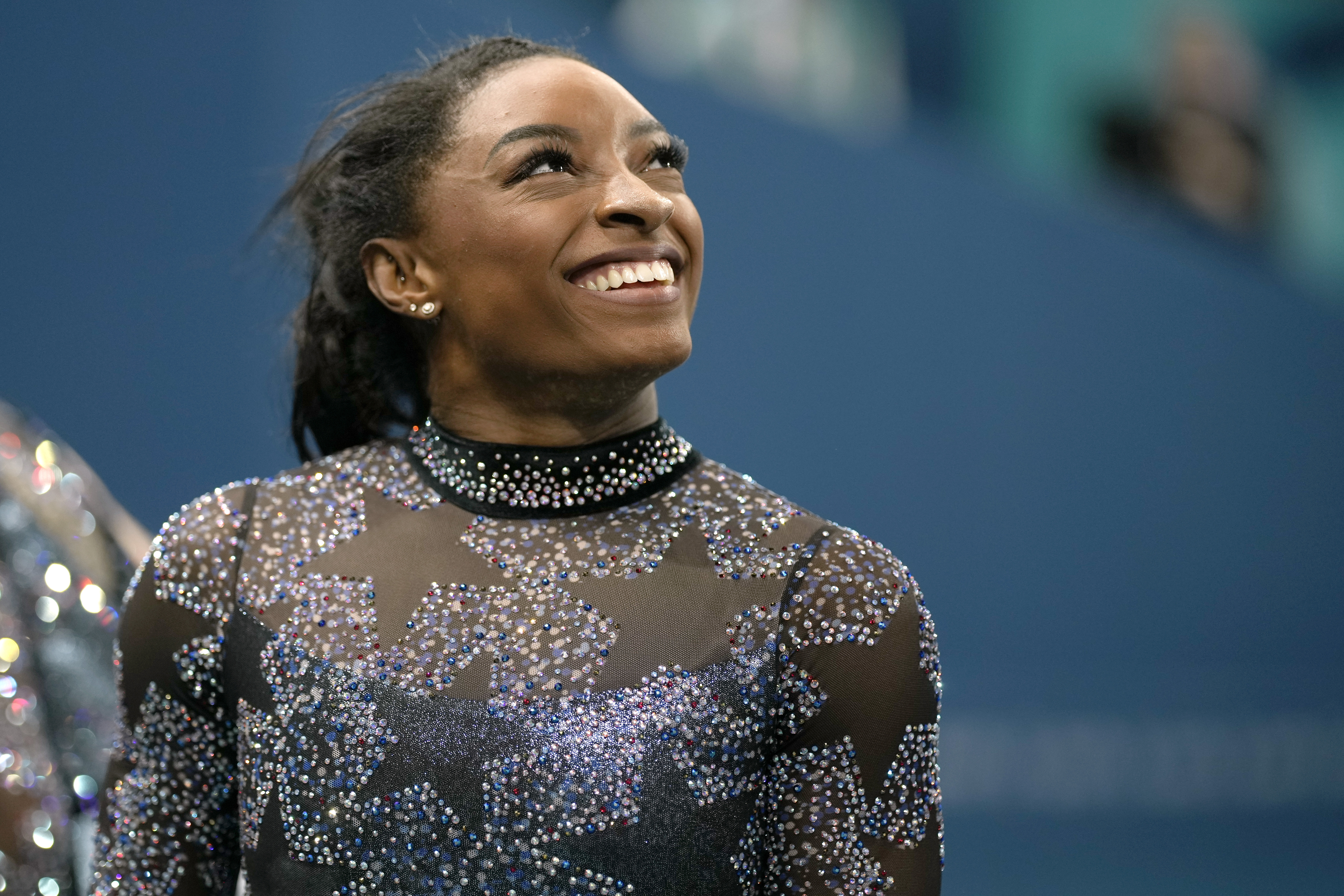 Simone Biles of United States, smiles after competing on the uneven bars during a women's artistic gymnastics qualification round at Bercy Arena at the 2024 Summer Olympics, Sunday, July 28, 2024, in Paris, France. 