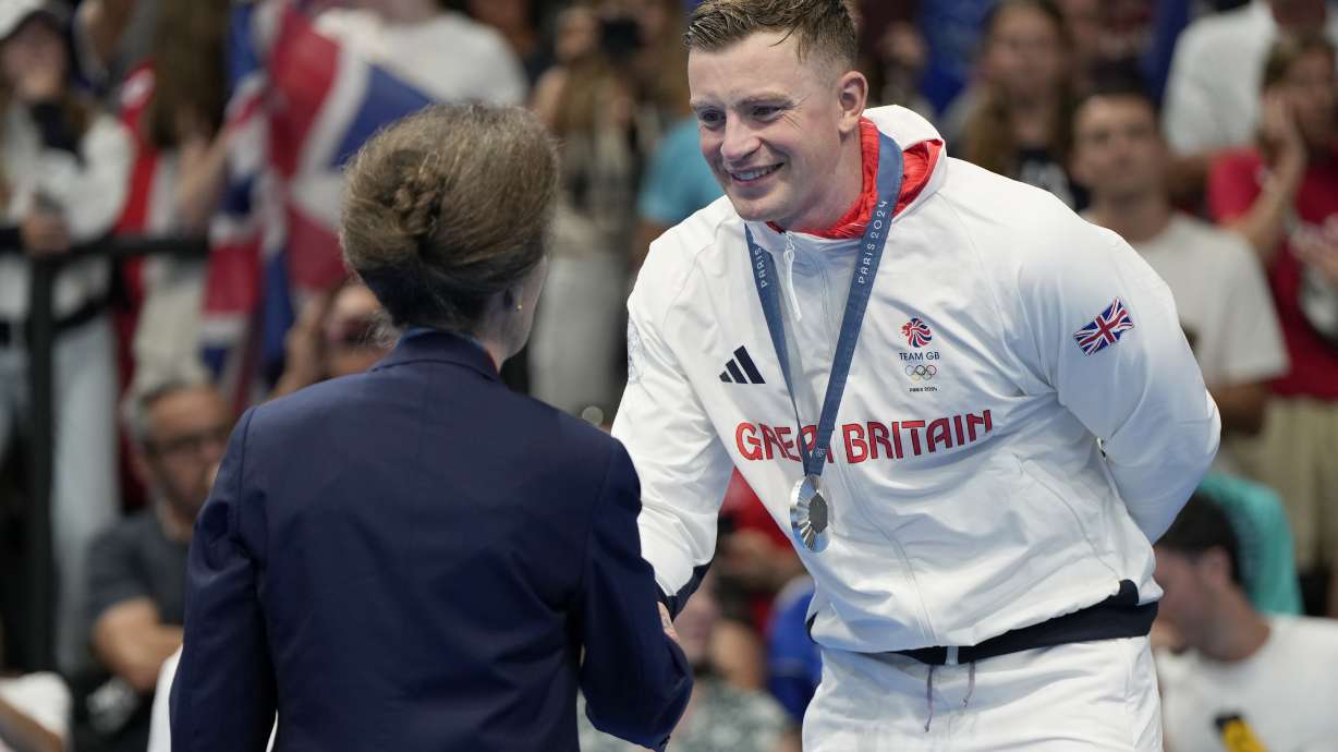 Britain's Princess Anne, left, congratulates Adam Peaty, of Britain, after winning the silver medal in the men's 100-meter breaststroke final at the 2024 Summer Olympics, Sunday, July 28, 2024, in Nanterre, France.