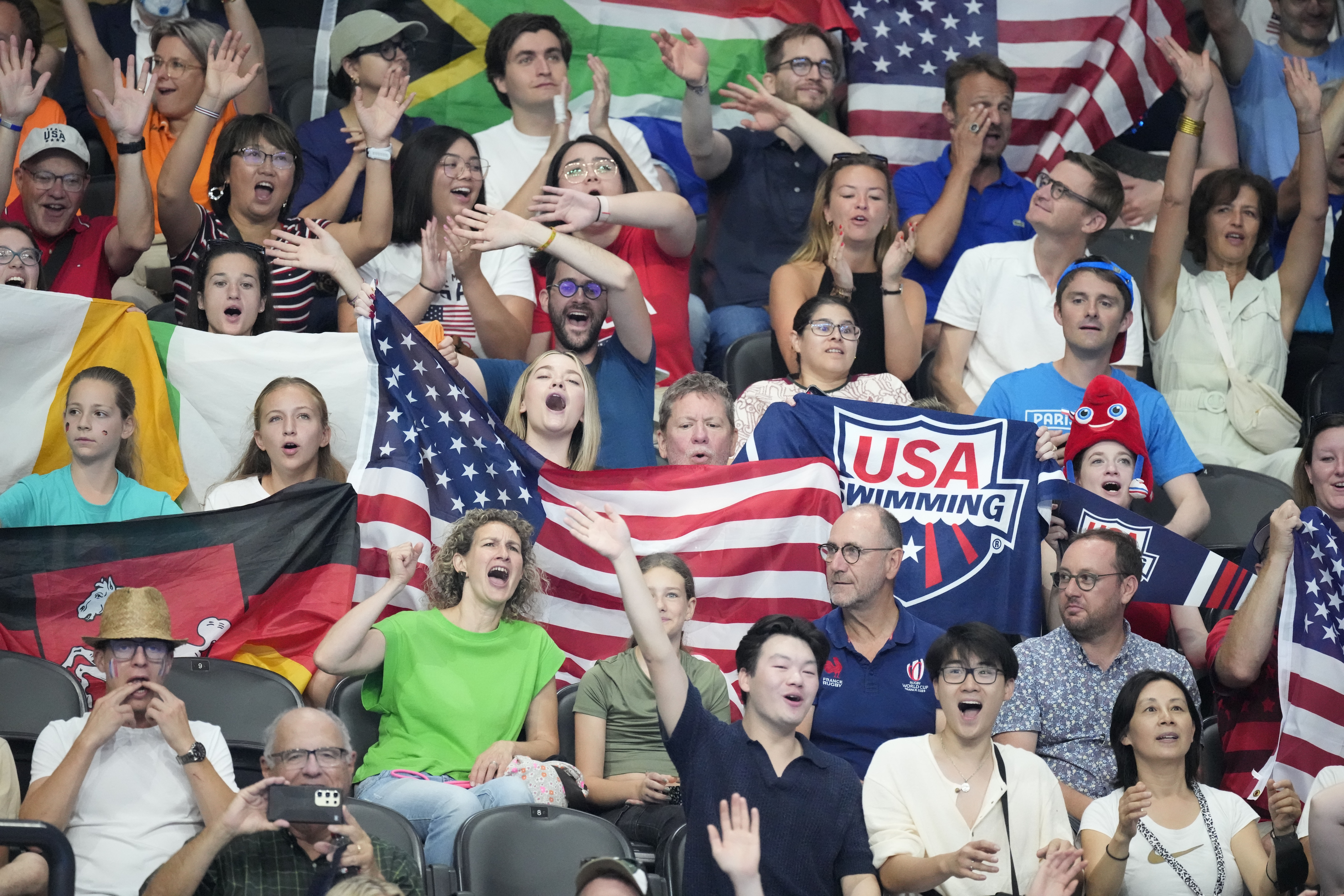 Fans cheer before the start of the swimming program at the 2024 Summer Olympics, Monday, July 29, 2024, in Nanterre, France. 
