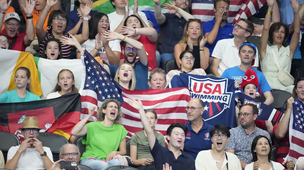 Fans cheer before the start of the swimming program at the 2024 Summer Olympics, Monday, July 29, 2024, in Nanterre, France.