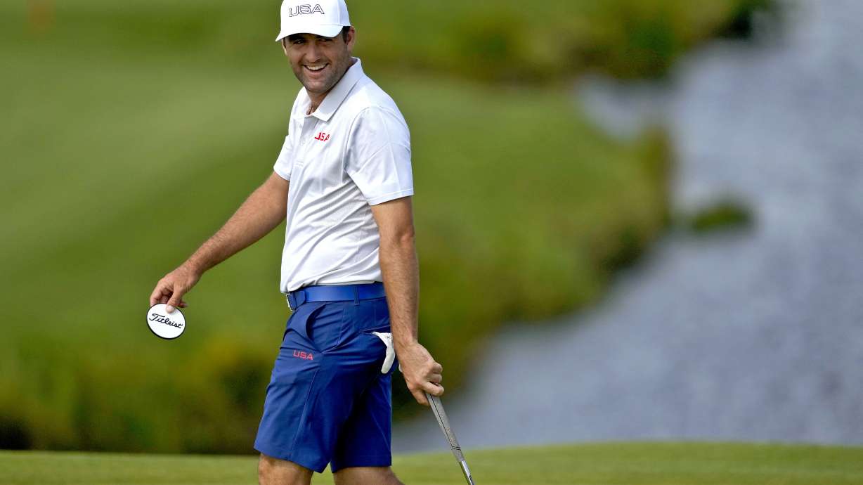 Scottie Scheffler, of the United States, smiles on the 11th green during a practice round for the men's golf event at the 2024 Summer Olympics, Monday, July 29, 2024, at Le Golf National in Saint-Quentin-en-Yvelines, France.