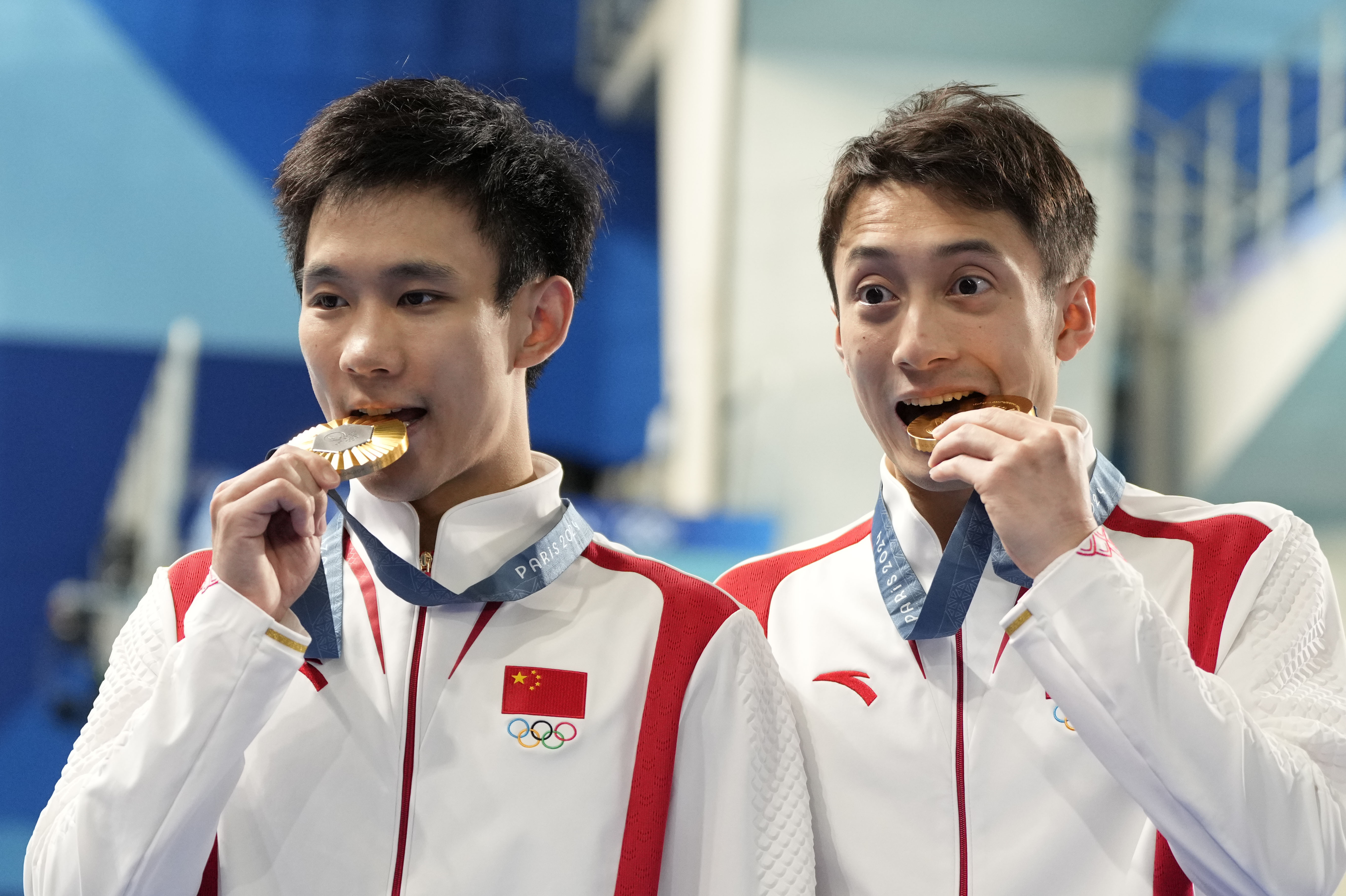 China's Lian Junjie and Yang Hao celebrate on the podium after winning the gold medal in the men's synchronised 10m platform diving final at the 2024 Summer Olympics, Monday, July 29, 2024, in Saint-Denis, France. 