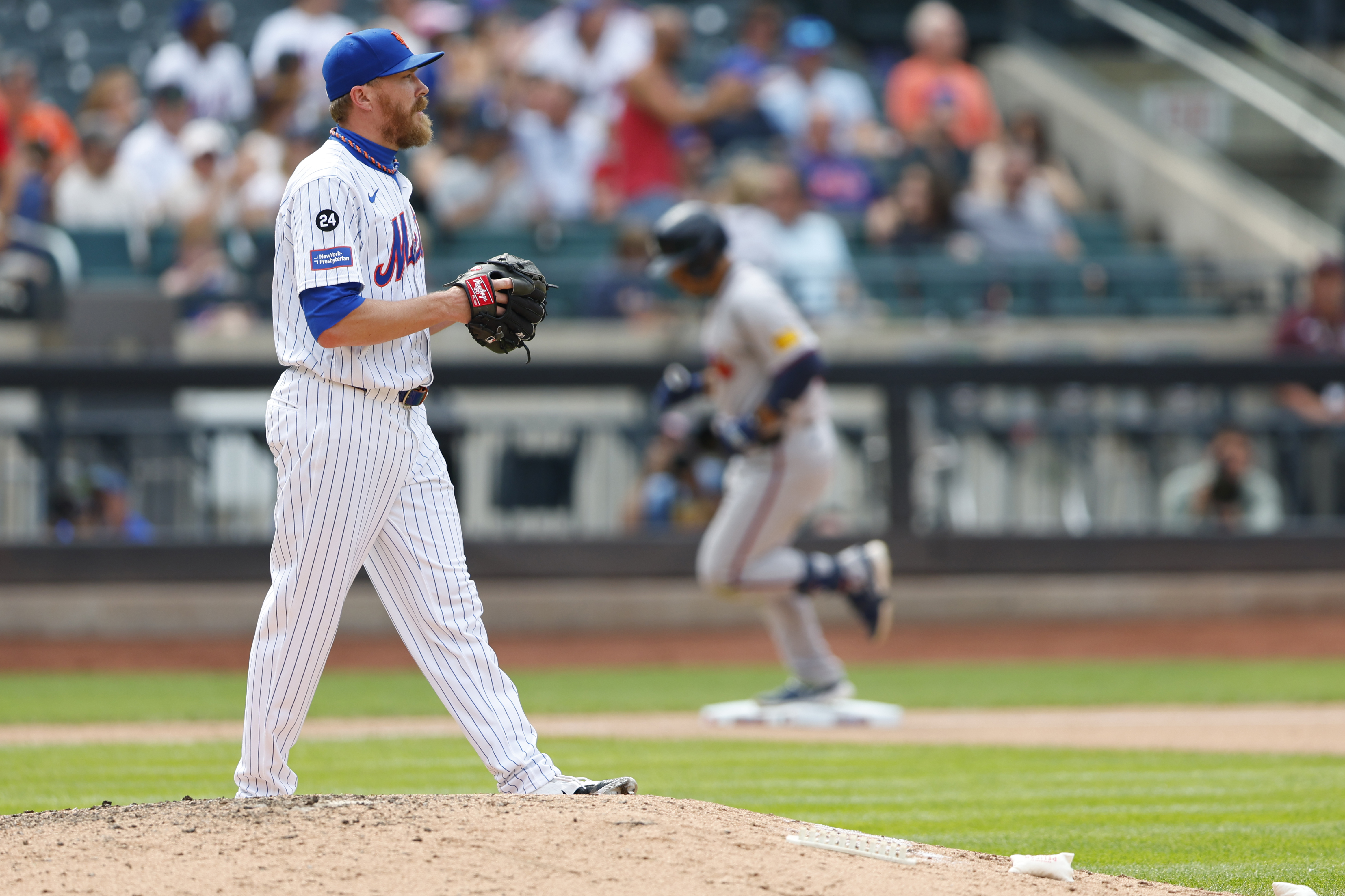 New York Mets relief pitcher Jake Diekman stares into the outfield as Atlanta Braves' Ramón Laureano rounds third base after hitting a two-run home run in the eighth inning of a baseball game Sunday, July 28, 2024, in New York. 